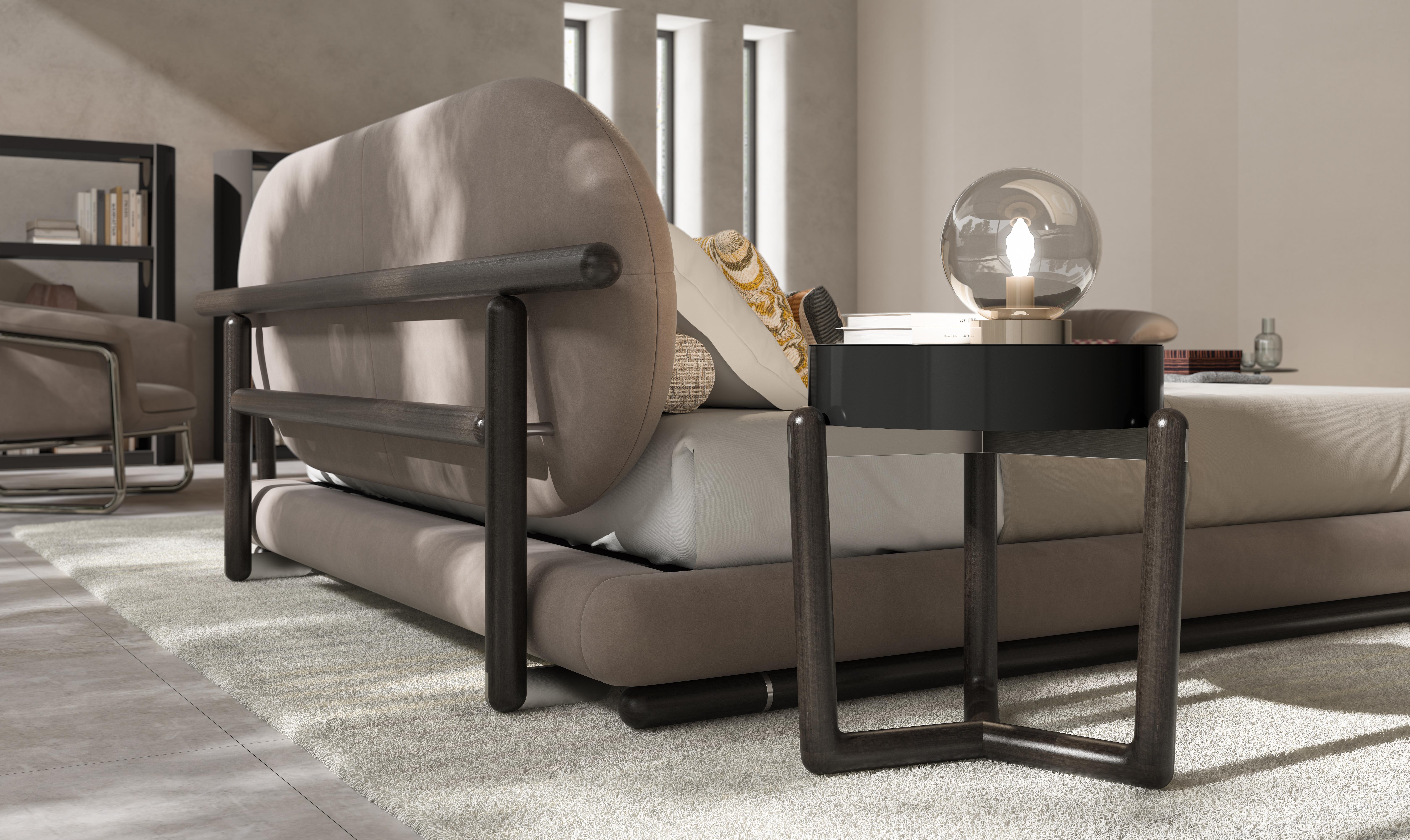 This nightstand features a solid wooden frame, constructed from three legs, that provide both stability and a natural, rustic appeal. The drawers are lacquered, offering a sleek and polished finish that contrasts beautifully with the warmth of the