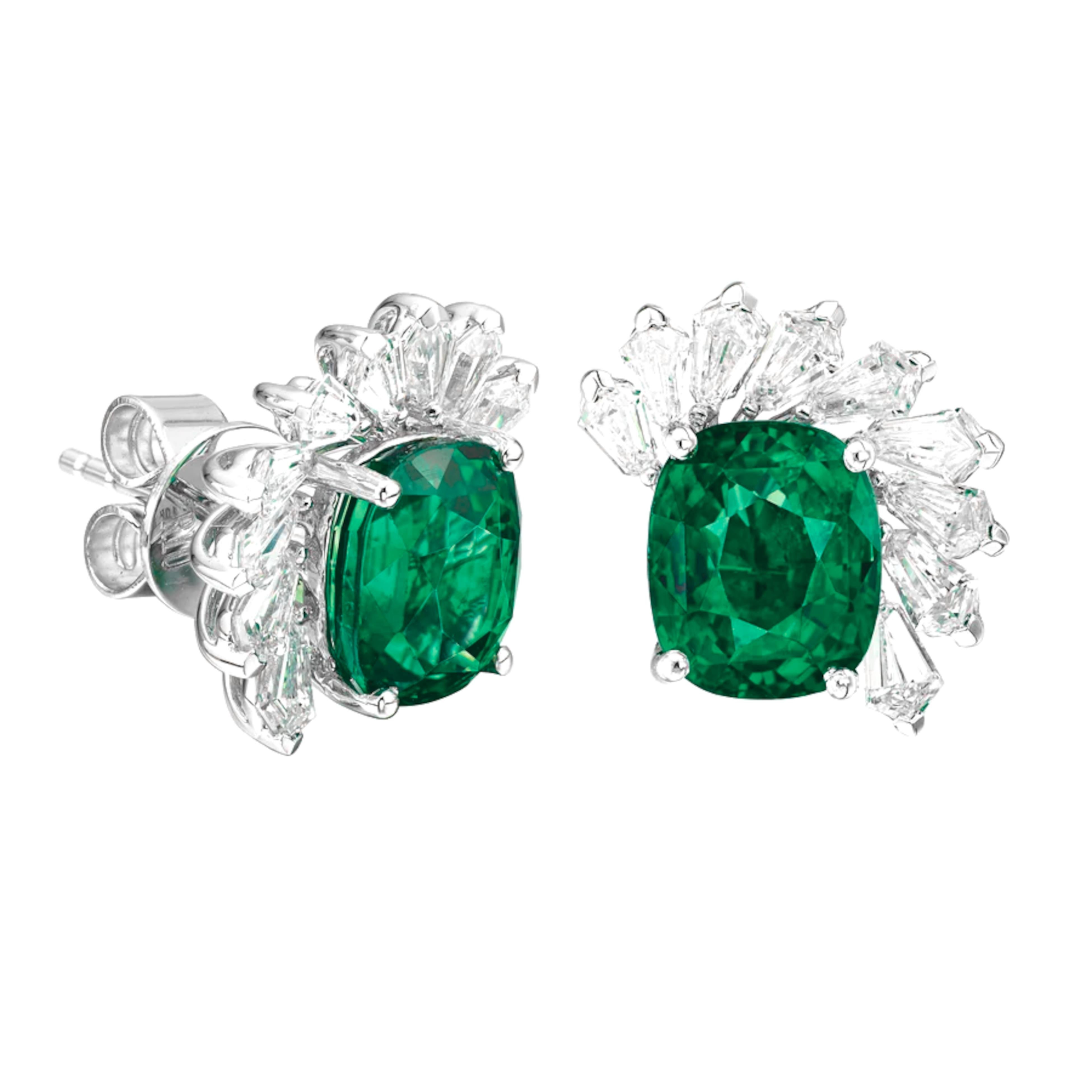 These Cecile Blake earrings are a captivating combination of vibrant green emeralds and sparkling diamonds, perfect for adding a touch of elegance to any evening ensemble. The cushion-cut emeralds, known for their captivating green hue, are