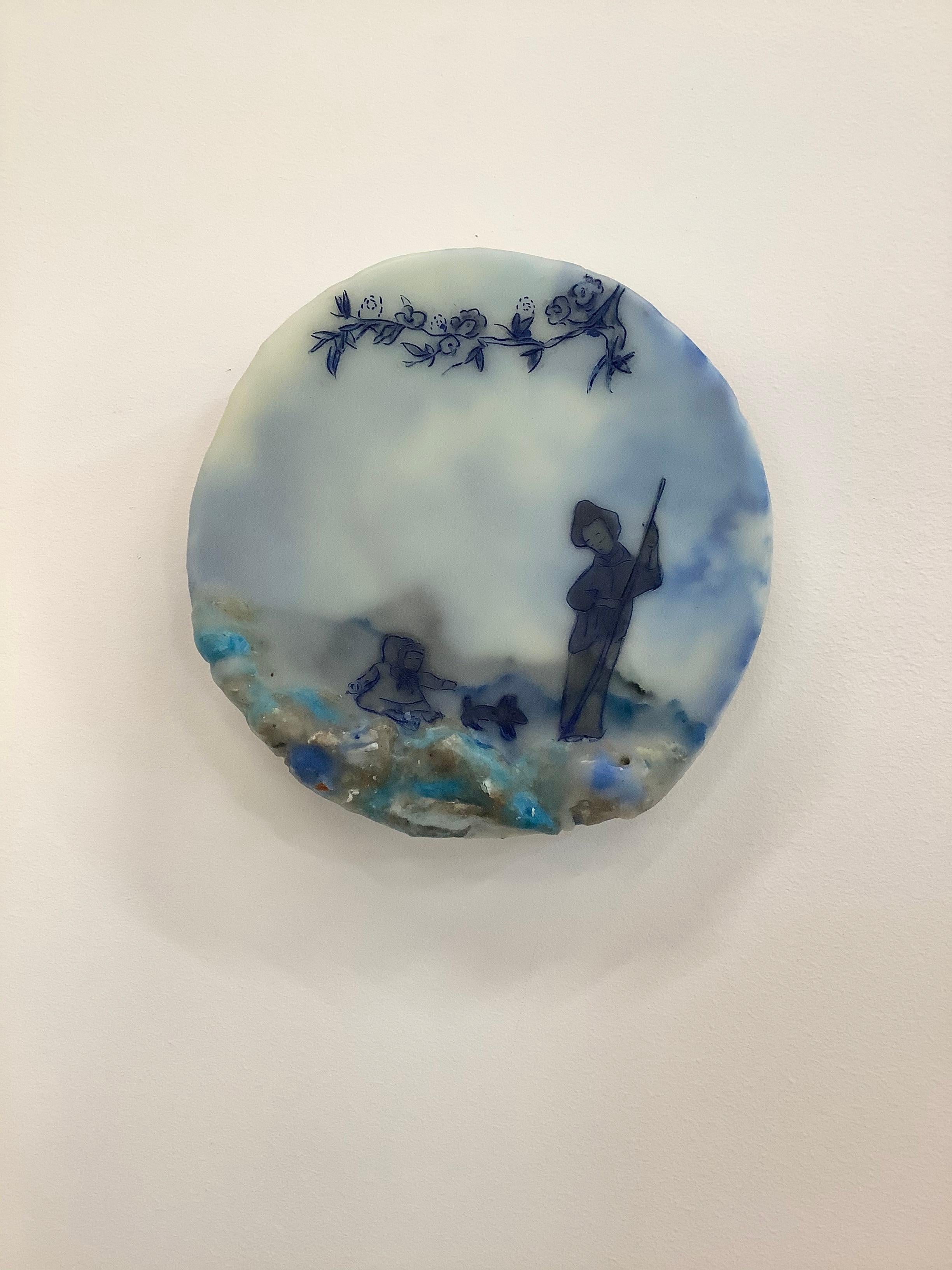 A peaceful landscape scene is set in shades of blue with pale yellow and ivory in this circular encaustic (pigmented beeswax) painting with oil, pigments from Morocco and India, volcanic ash from Ecuador, rice paper, gold leaf, electronic components