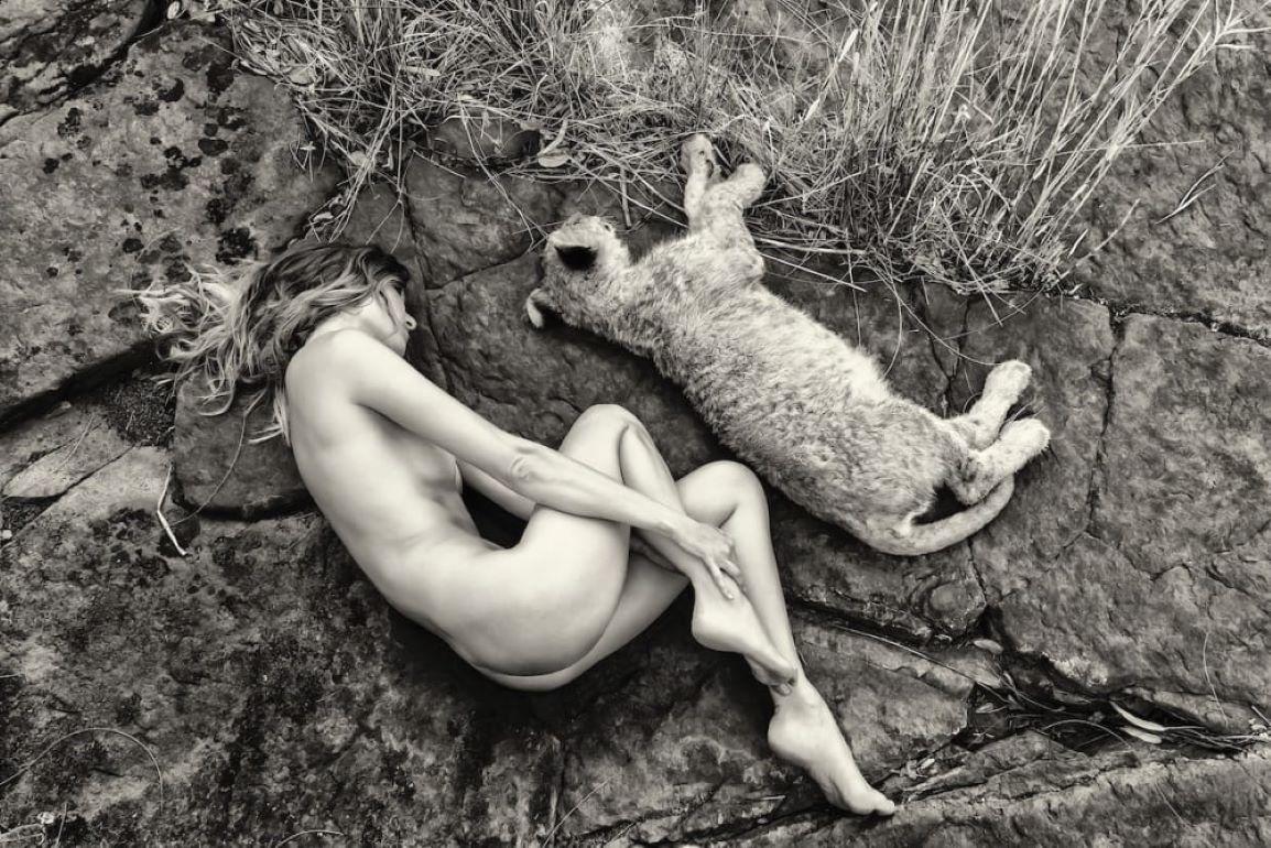 "Sleeping",  black and white photograph of a lion cub by Cécile Plaisance.

In her new series of black and white photographs, taken in South Africa, Cécile Plaisance immerses her models in a nature that is unfortunately in danger, free and in