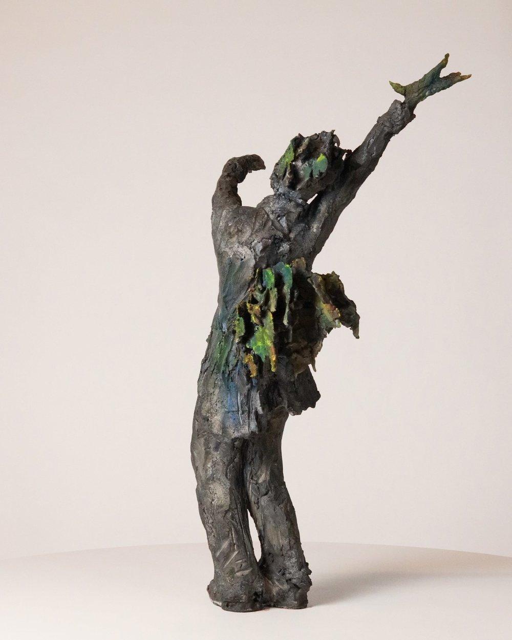 This piece represents a human figure with a tail and a headdress in feather. In this sculpture the birdcatcher, a man who is catching birds with nets and traps, seems to transform into a bird himself. In recent years, animals have taken an