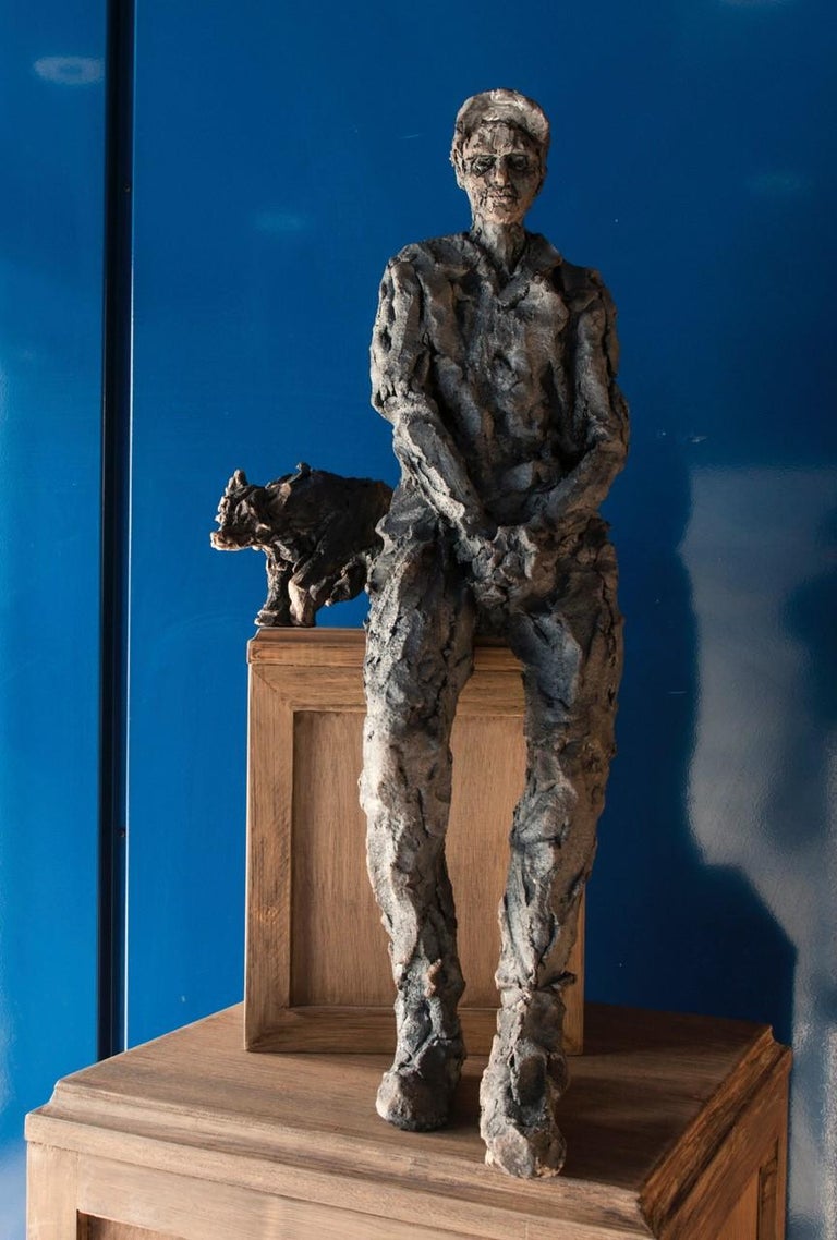 Rêve de loup - avec Gabriel-le (A Wolf's Dream, with Gabriel-le), by contemporary French artist Cécile Raynal. 
Smoke-fired stoneware sculpture, base made of three wood boxes, 180 cm × 45 cm × 45 cm.
Dimensions of the human figure: H 60 cm 
Total