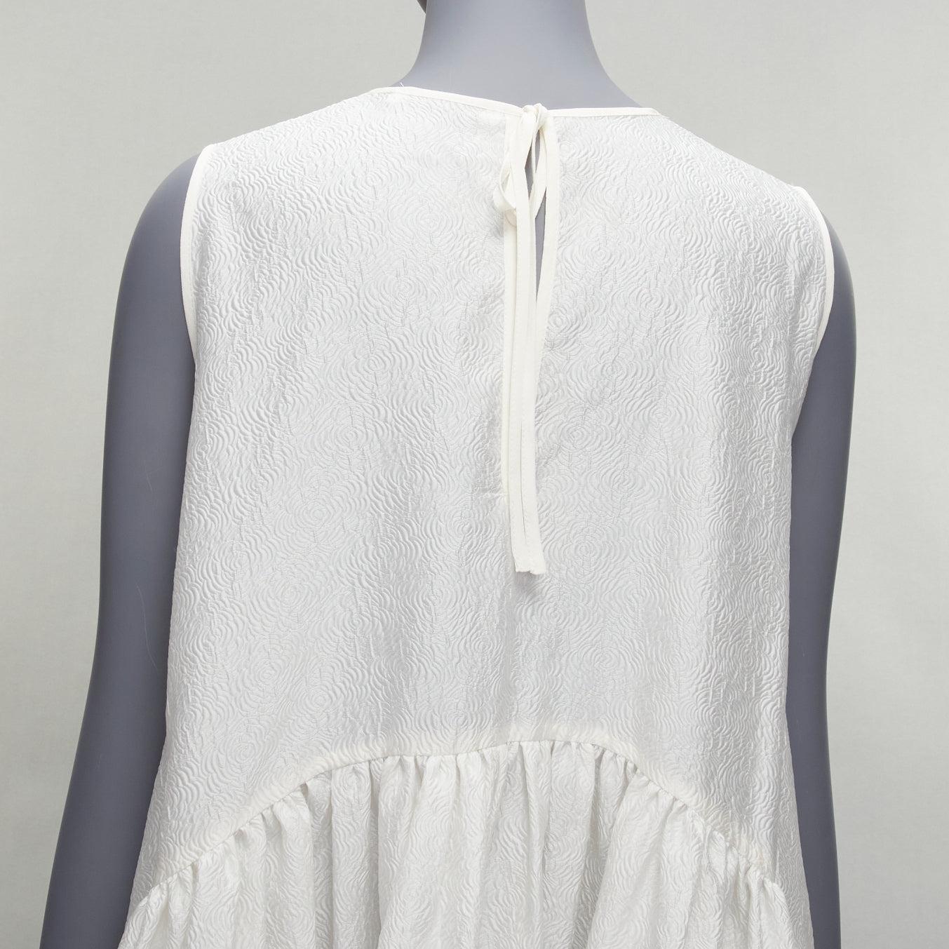CECILIE BAHNSEN white silk blend jacquard sleeveless babydoll midi dress UK6 XS
Reference: LNKO/A02186
Brand: Cecilie Bahnsen
Material: Silk, Blend
Color: White
Pattern: Floral
Closure: Self Tie
Lining: White Fabric
Extra Details: Tie neck at back.