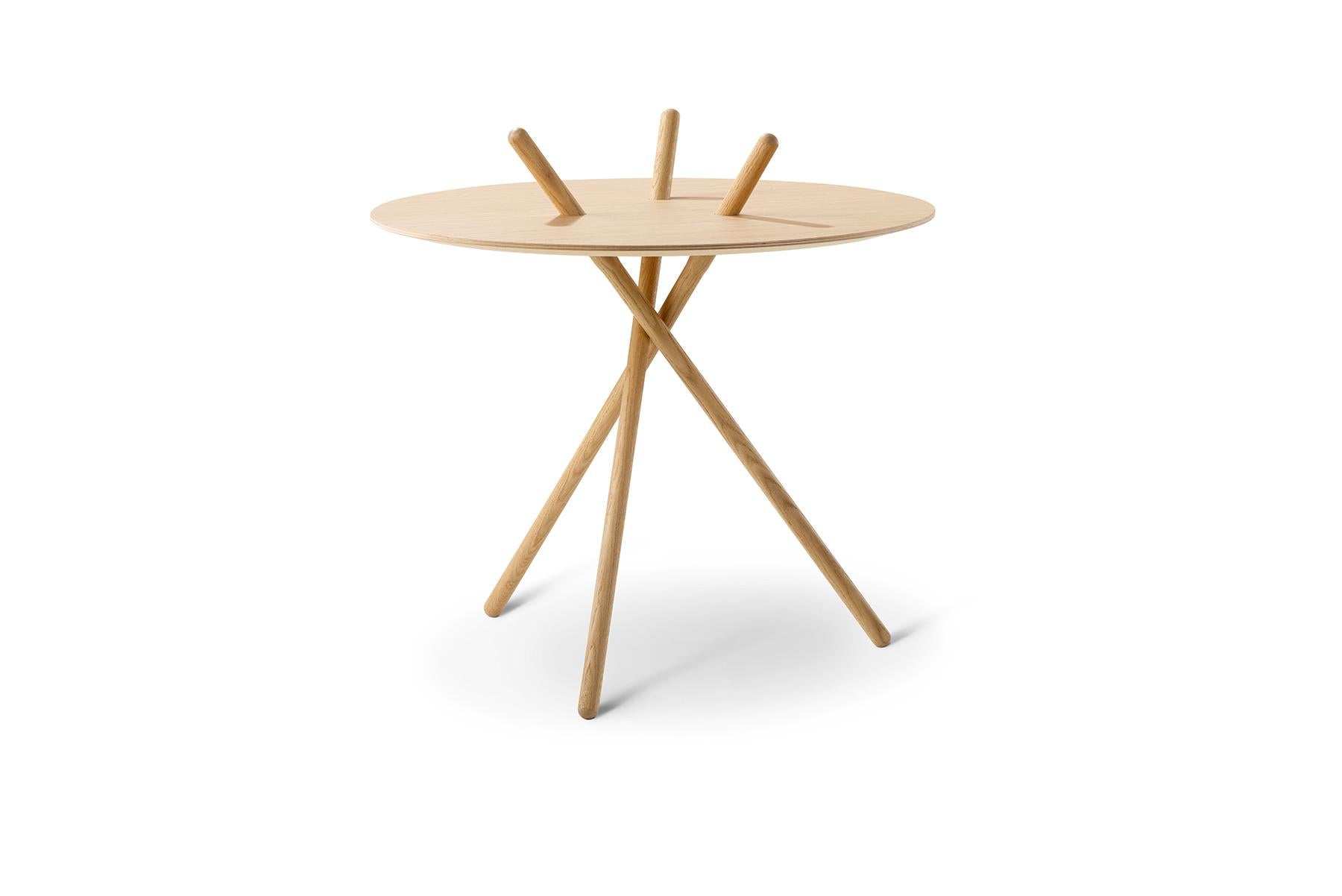 A game using sticks was the inspiration behind Cecilie Manz Micado coffee table. The simple, three-legged construction is assembled without hardware and supports itself.