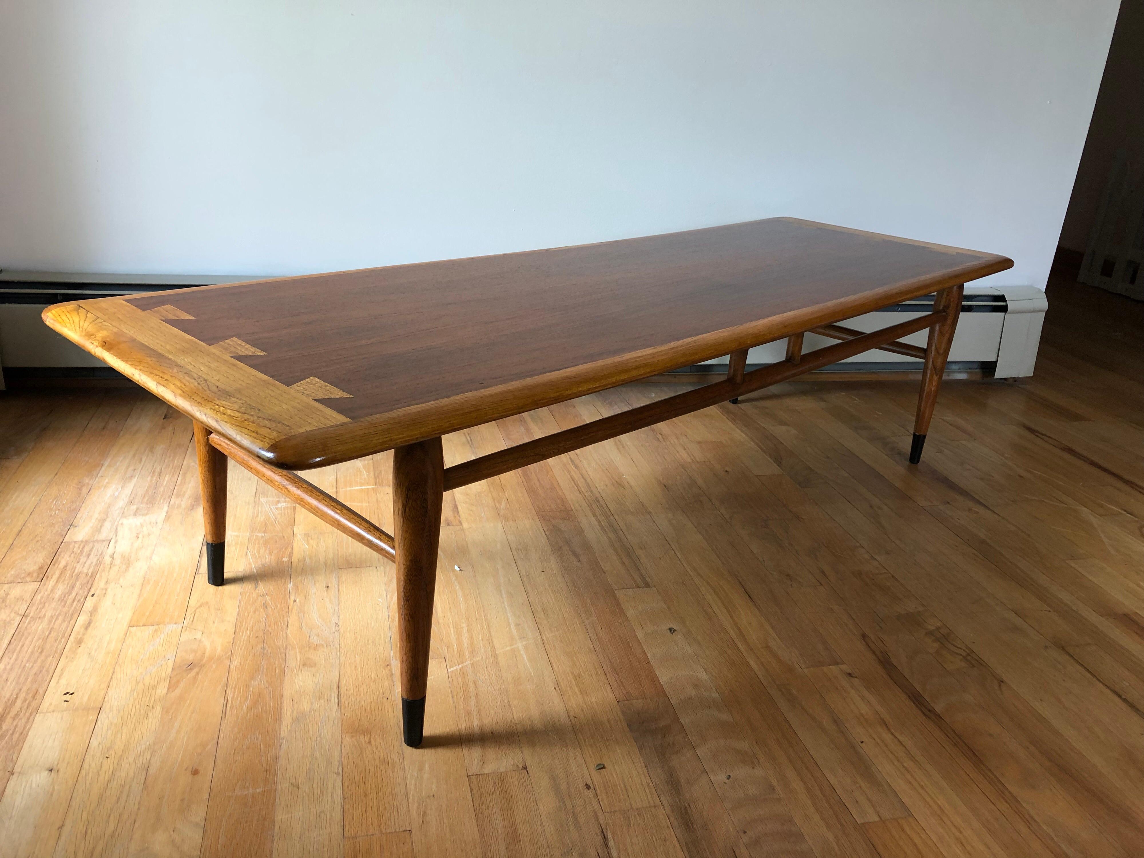 A cedar, oak, and walnut dovetail coffee table by Lane, circa 1965. Raised on turned tapering legs with ebonite feet, with turned stretchers. Burnished mark on underside, Lane Altavista, Virginia. Expertly restored.