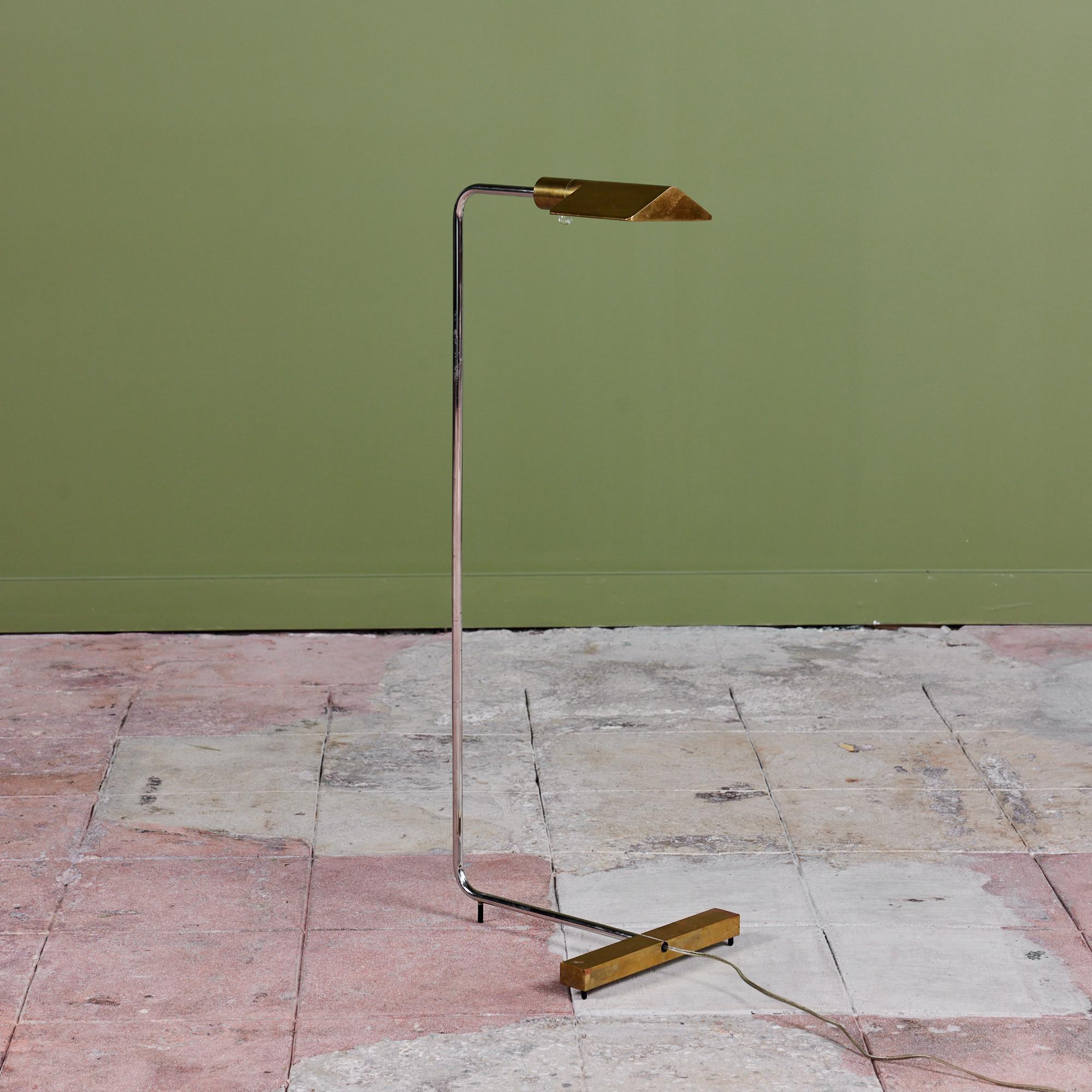 Designed in the 1970s, this brass and stainless steel floor lamp by Cedric Hartman is an enduring design classic. The modernist floor lamp features a triangular brass shade attached to a curved stainless steel stem that offer focused task lighting.