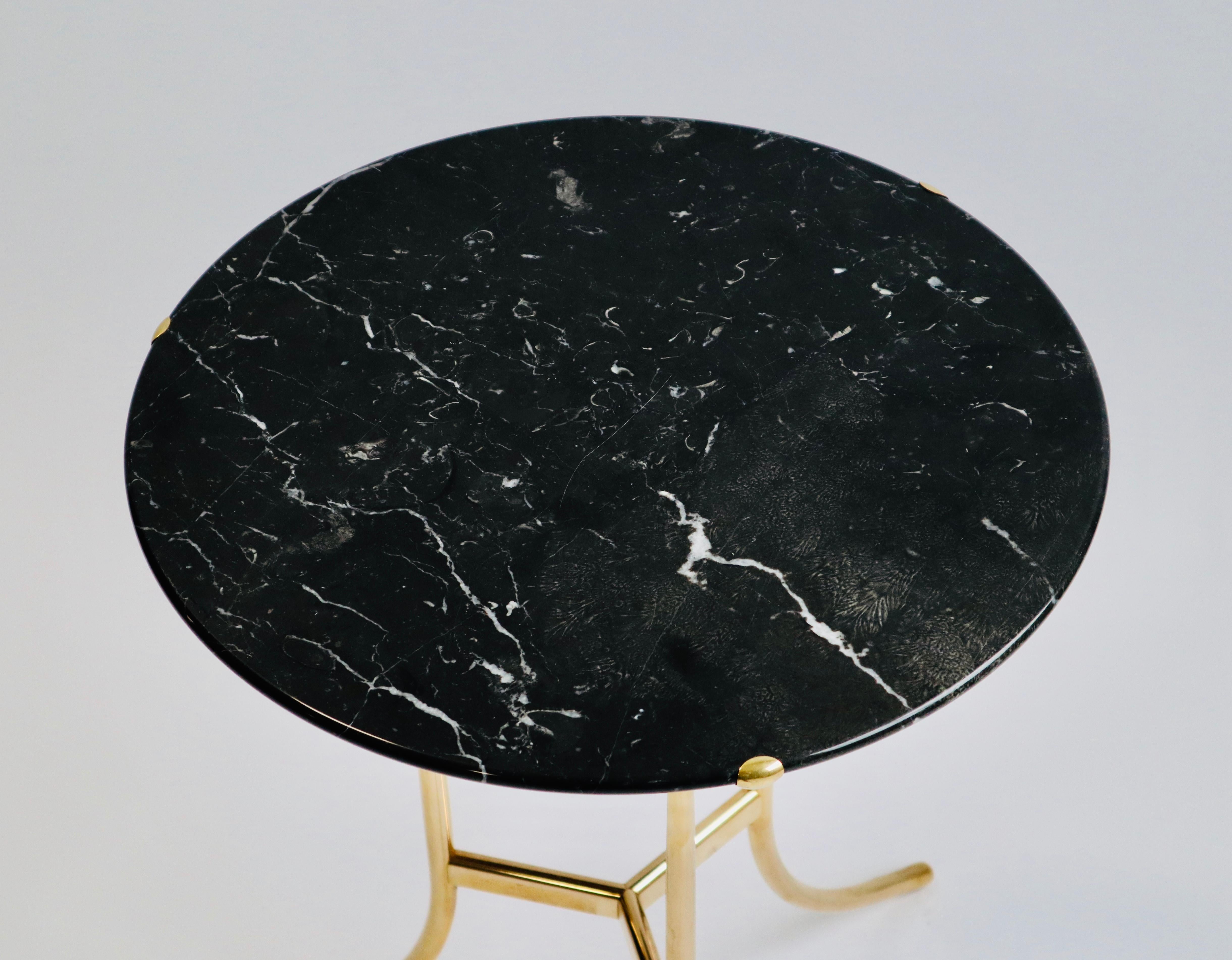 Side table designed by Cedric Hartman, signed and numbered. Brass frame with black marble top.