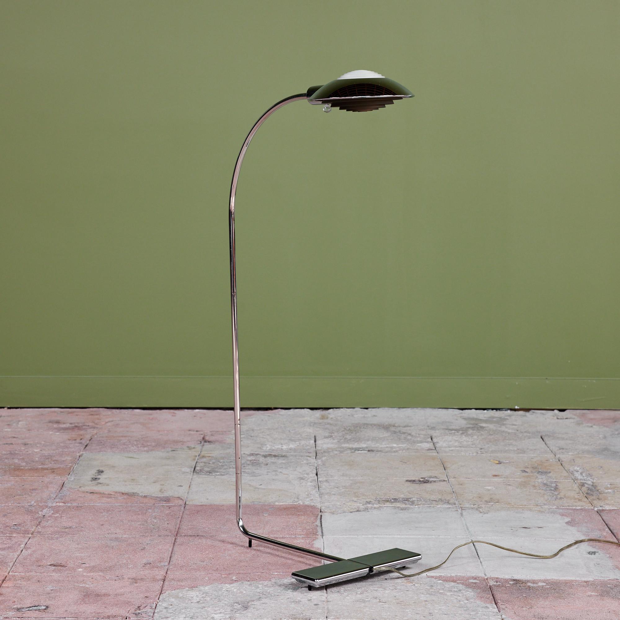Designed in the 1970s, this chrome floor lamp by Cedric Hartman is an enduring design classic. The modernist floor lamp features a chrome dome shade attached to a curved aluminum stem that offer focused task lighting. The arched pole terminates into