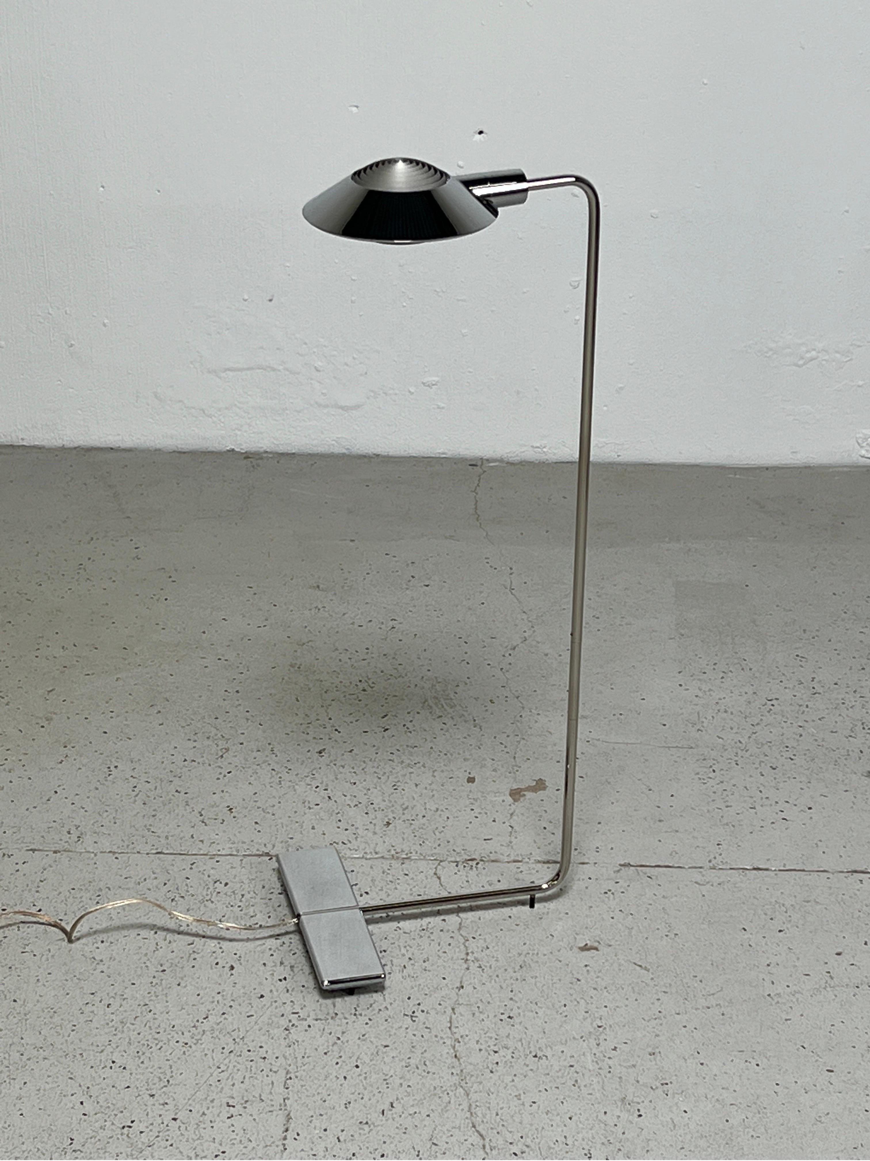 A chrome floor lamp by Cedric Hartman. Adjustable height and rotating hood.