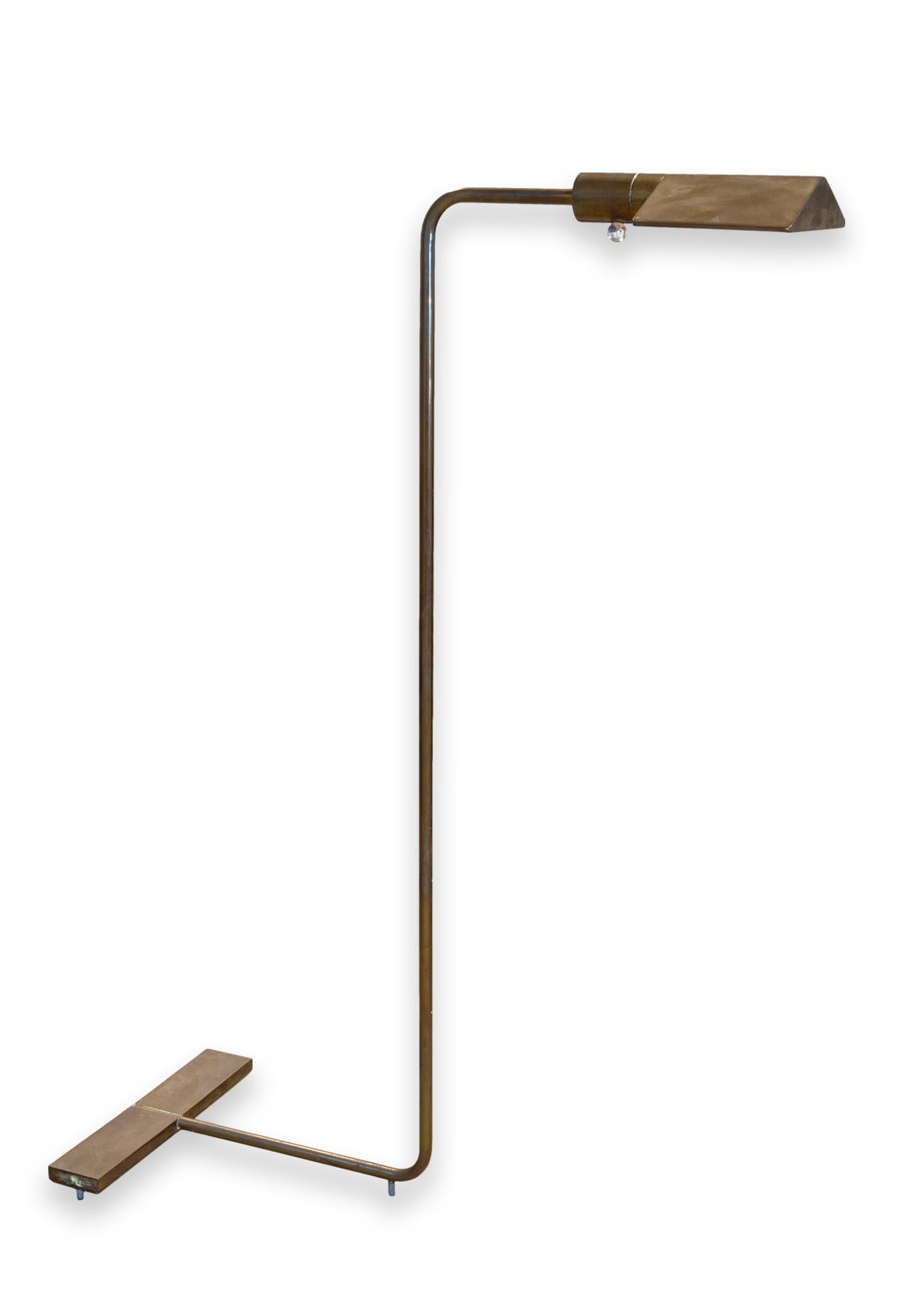A Cedric Hartman signed floor lamp. A beautiful floor lamp featuring a full polished brass construction with wonderful patina. This lamp is full adjustable from the center pole, the lamp shade, and the dimming of the light to fully fit your space