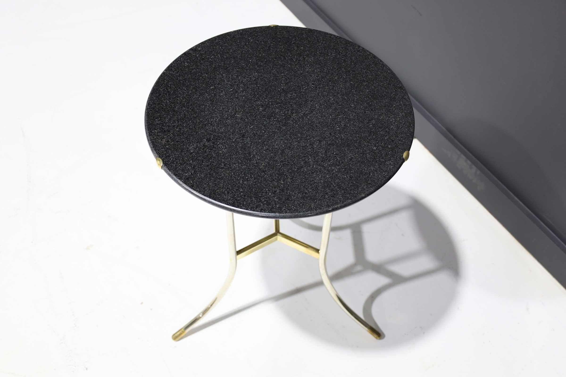 A classic Cedric Hartman table. Polished steel and brass base with polished black granite top. Signed and numbered.