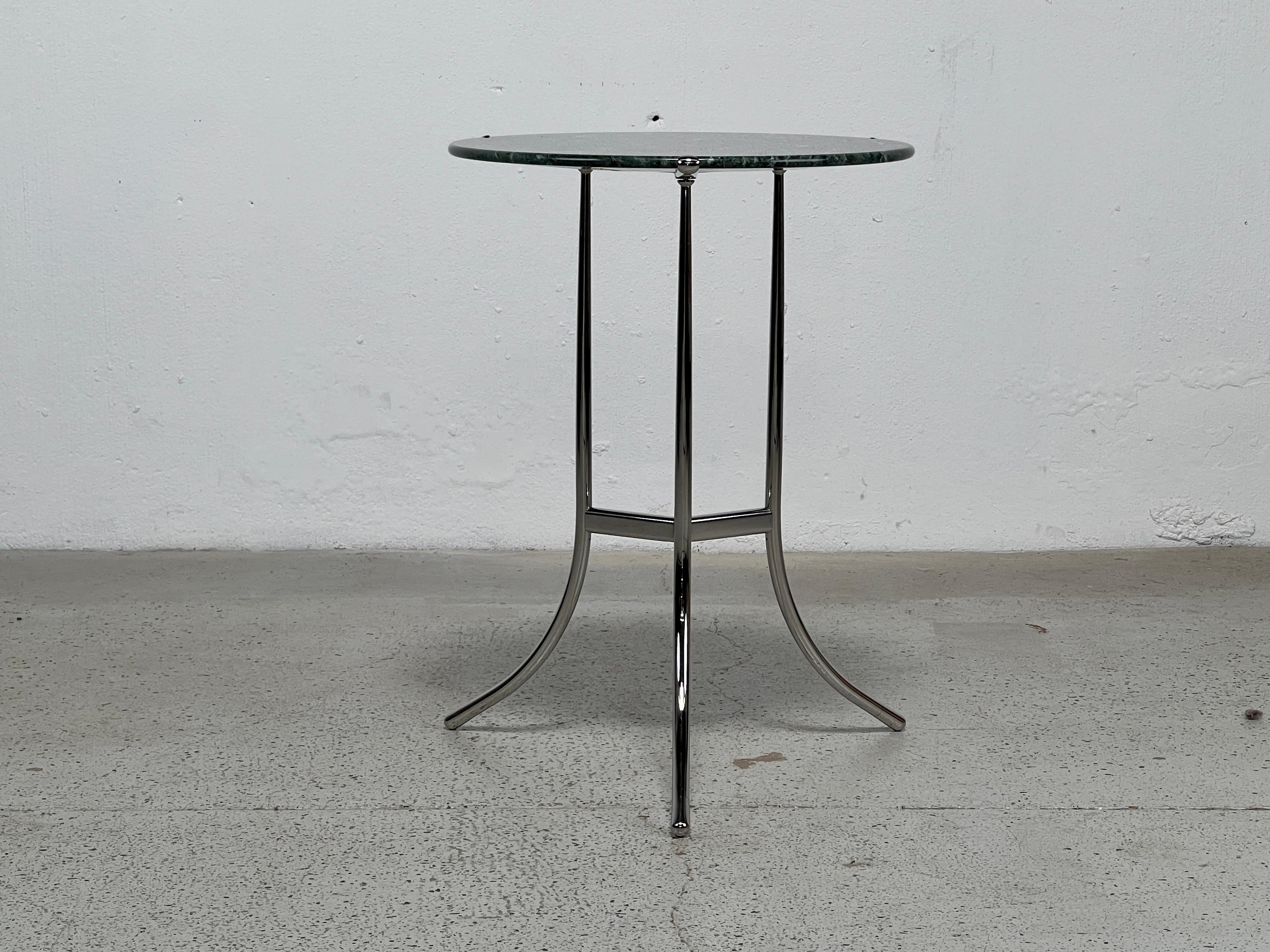 A polished chrome side table with green marble top by Cedric Hartman. 