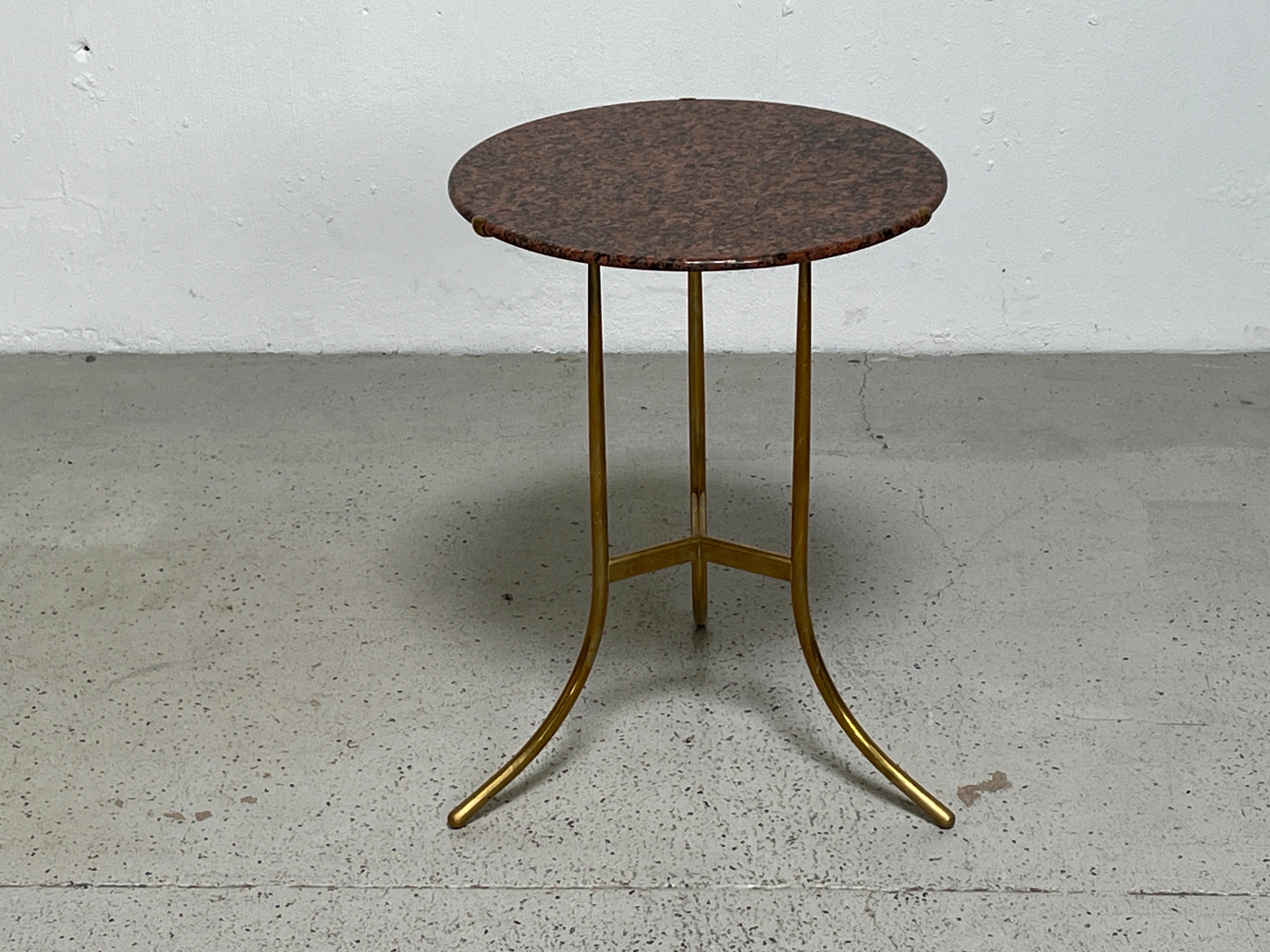 A brass side table with Rosso Tranas Rubino granite top designed by Cedric Hartman. 