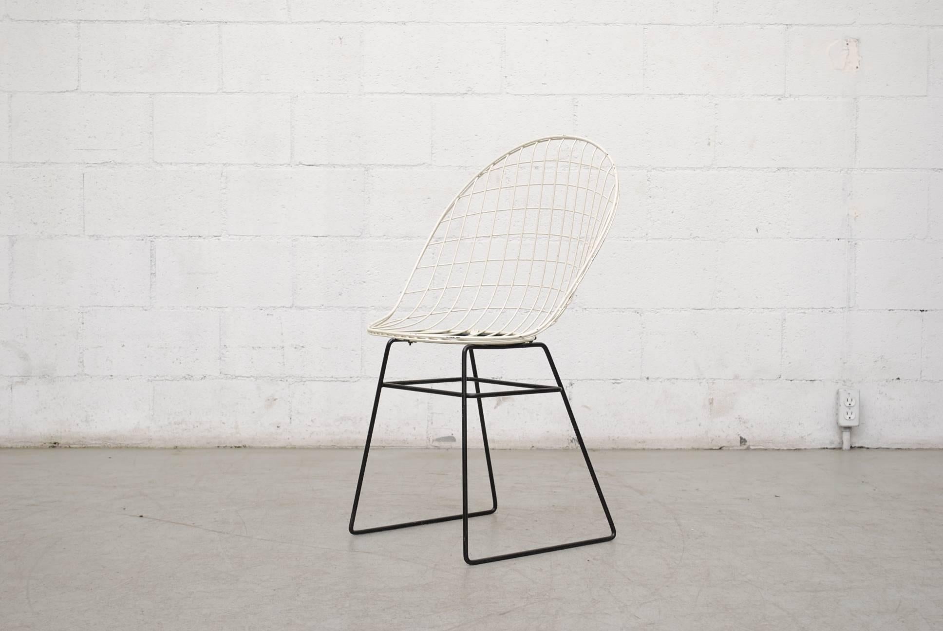 White wire enameled metal chair by Cees Braakman and Adriaan Dekker for Pastoe with black enameled metal frame in original condition with visible signs of wear consistent with its age and usage.