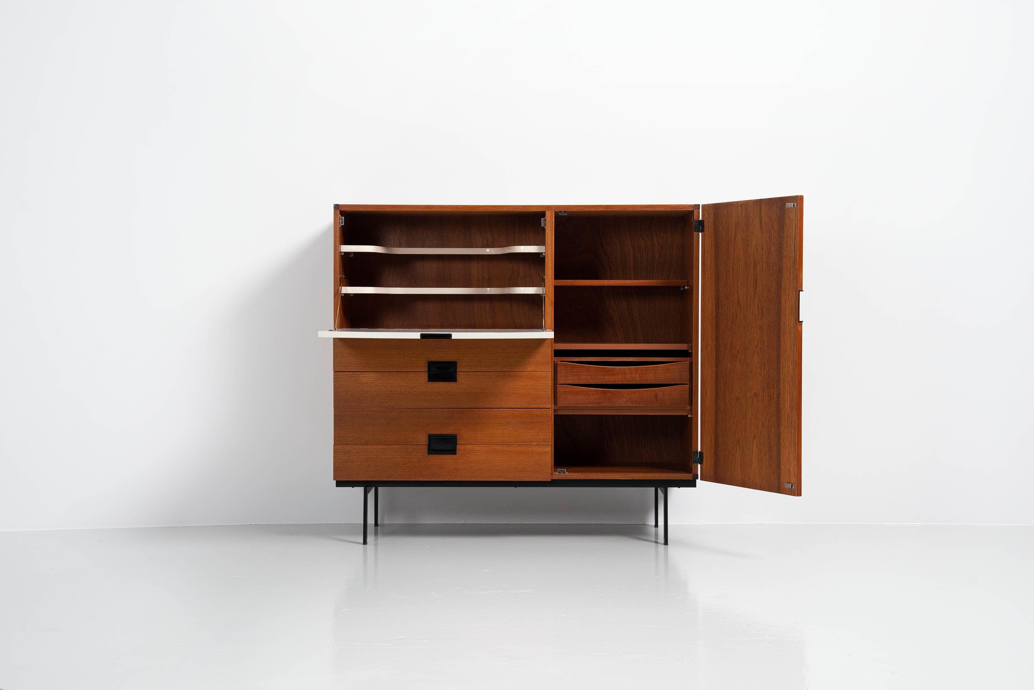 Very nice minimalist teak wooden cabinet model CU01 designed by Cees Braakman and manufactured by Pastoe UMS, Holland 1958. This is for model CU01 and has a drop down door on the left which is white painted and has 2 shelves behind for glasses and