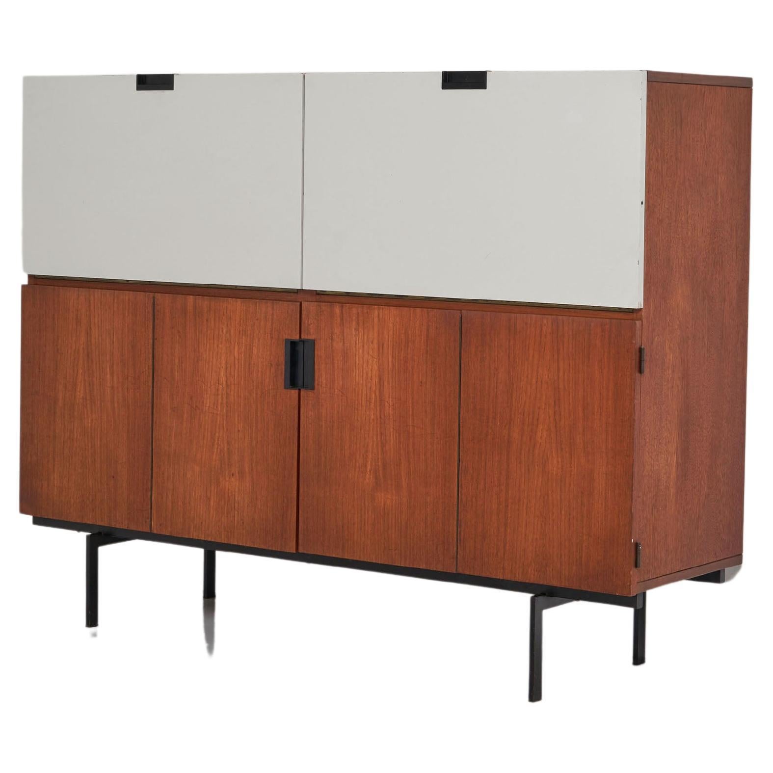 This is for a Minimalist model CU05 cabinet designed by Cees Braakman and manufactured by Pastoe UMS, The Netherlands 1958. This high cabinet is made of teak wood veneer and has a black painted metal frame. The handles are made of black plastic. The