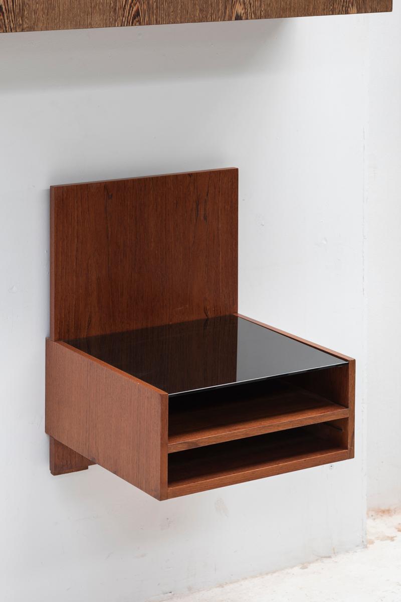 Floating night stand, designed by Cees Braakman and produced by Pastoe in the Netherlands around 1960. This item is from his famous Japanese series. A teak veneered wooden base with a black glass top. In good, restored condition with some using
