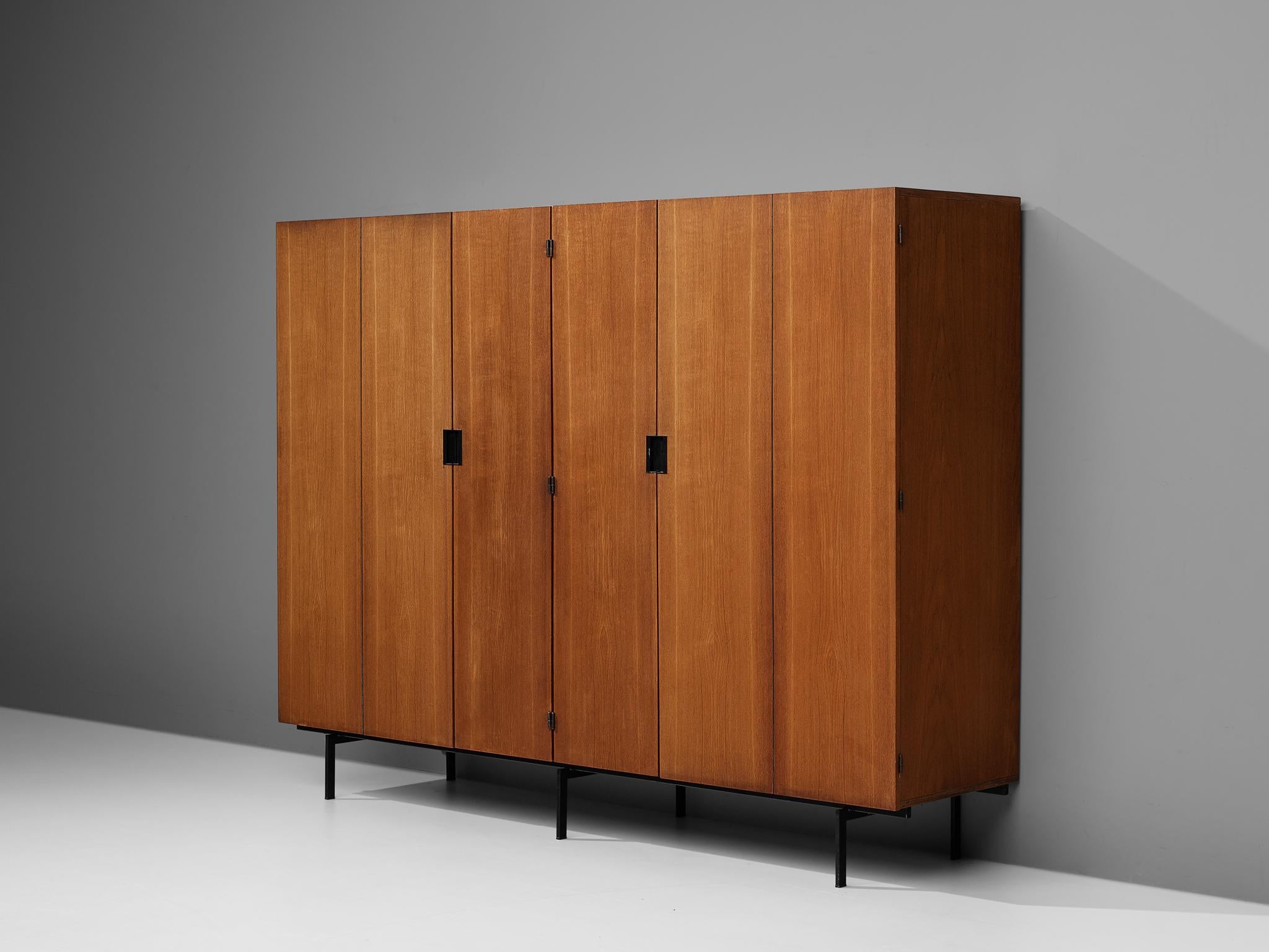 Cees Braakman for Pastoe, large wardrobe, teak, metal, the Netherlands, 1950s

On a slim black metal base rests this large wardrobe by Cees Braakman for Pastoe. Six doors, either bi-folded or single, access the inside which is structured with