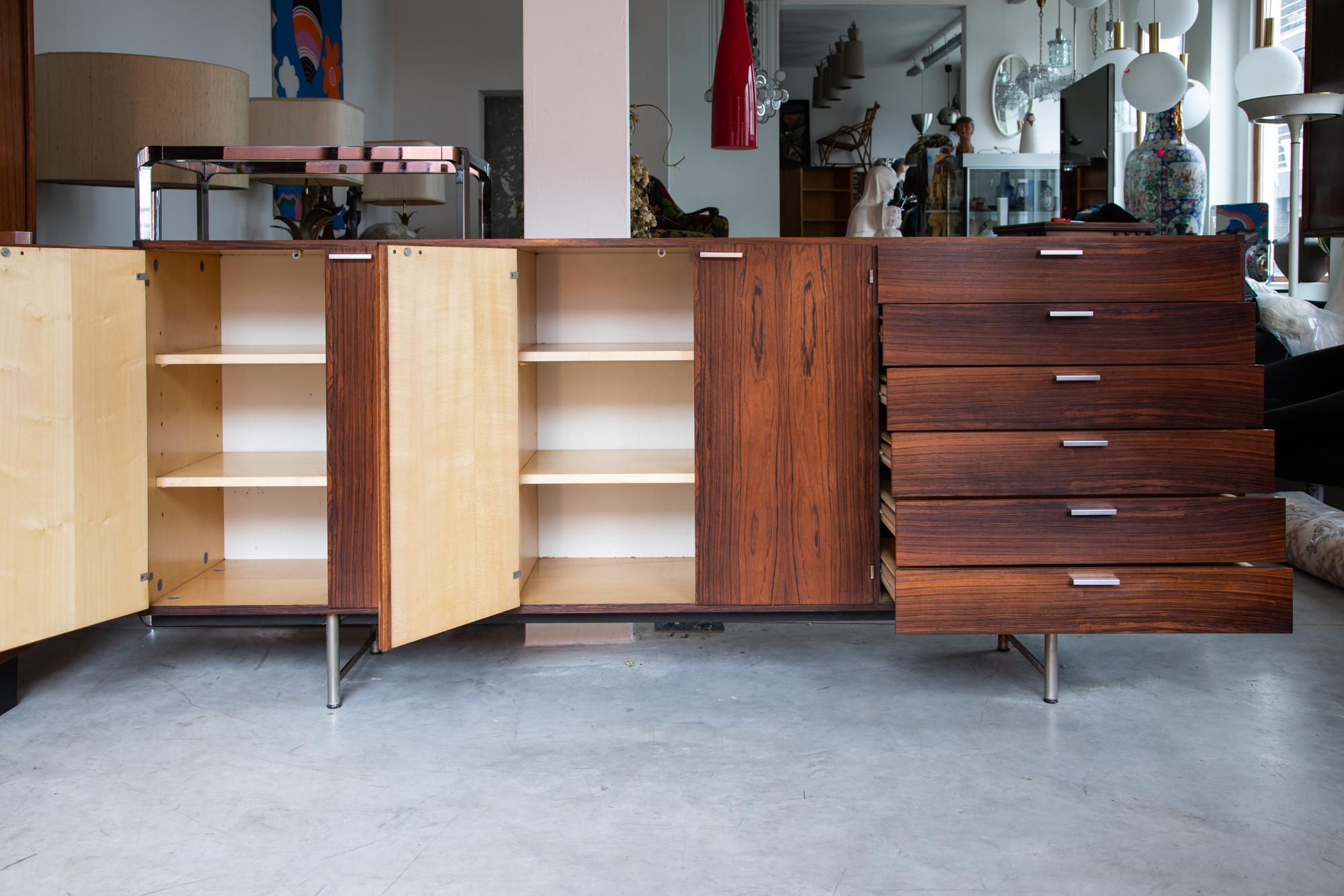 Beautiful midcentury modernist sideboard designed by Cees Braakman for UMS Pastoe, 1962, labeled, has a beech interior storage, metal drawer pulls and metal feet, 6 drawers and two shelving cabinets.
Top drawer is felted for silverware.
The