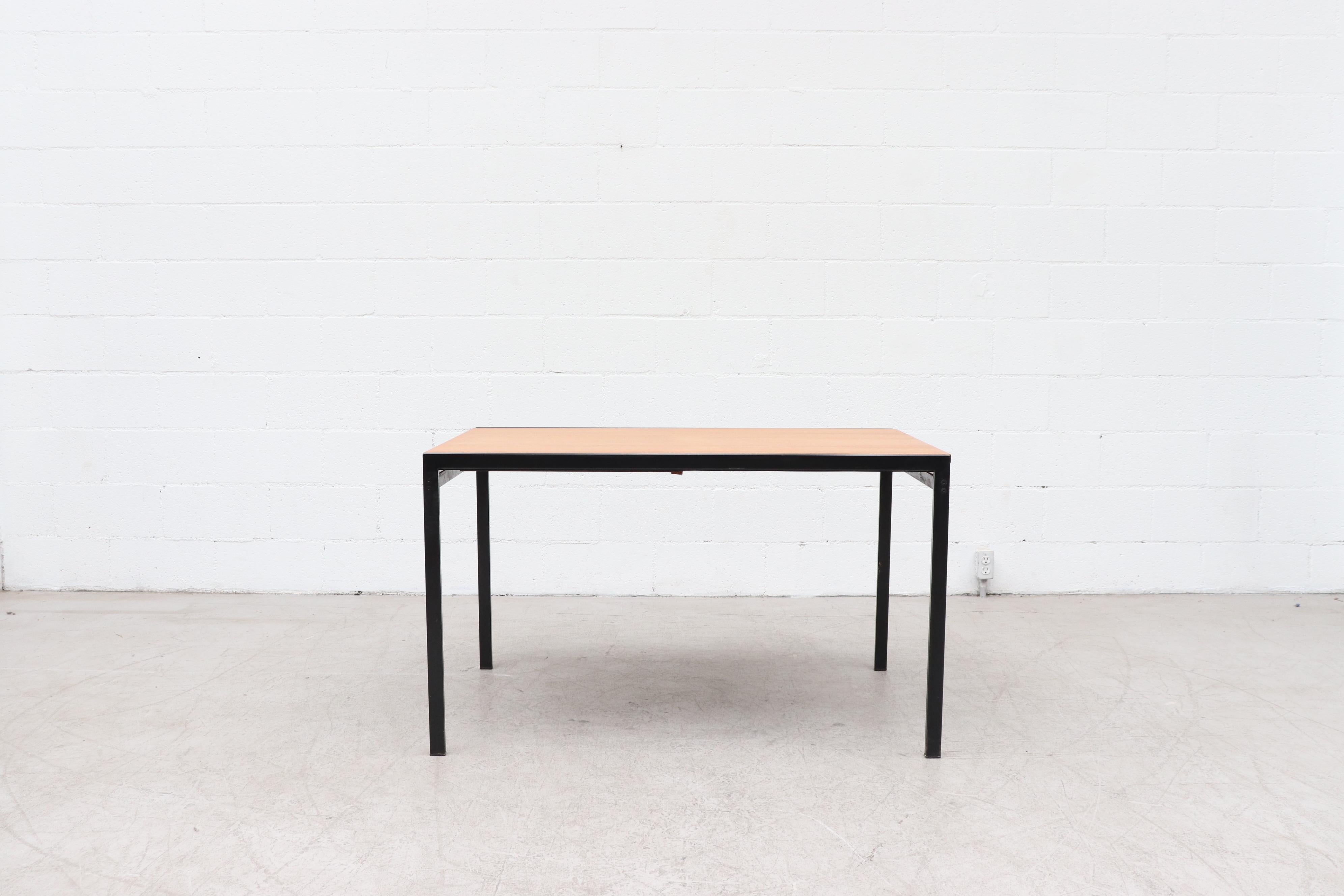 Beeindruckender Mid-Century-Esstisch der japanischen Serie von Cees Braakman mit versteckter Verlängerung für den niederländischen Nachkriegsmöbelriesen Pastoe. Leicht nachbearbeitete Teakholzplatte mit schwarz emailliertem Metallrahmen und