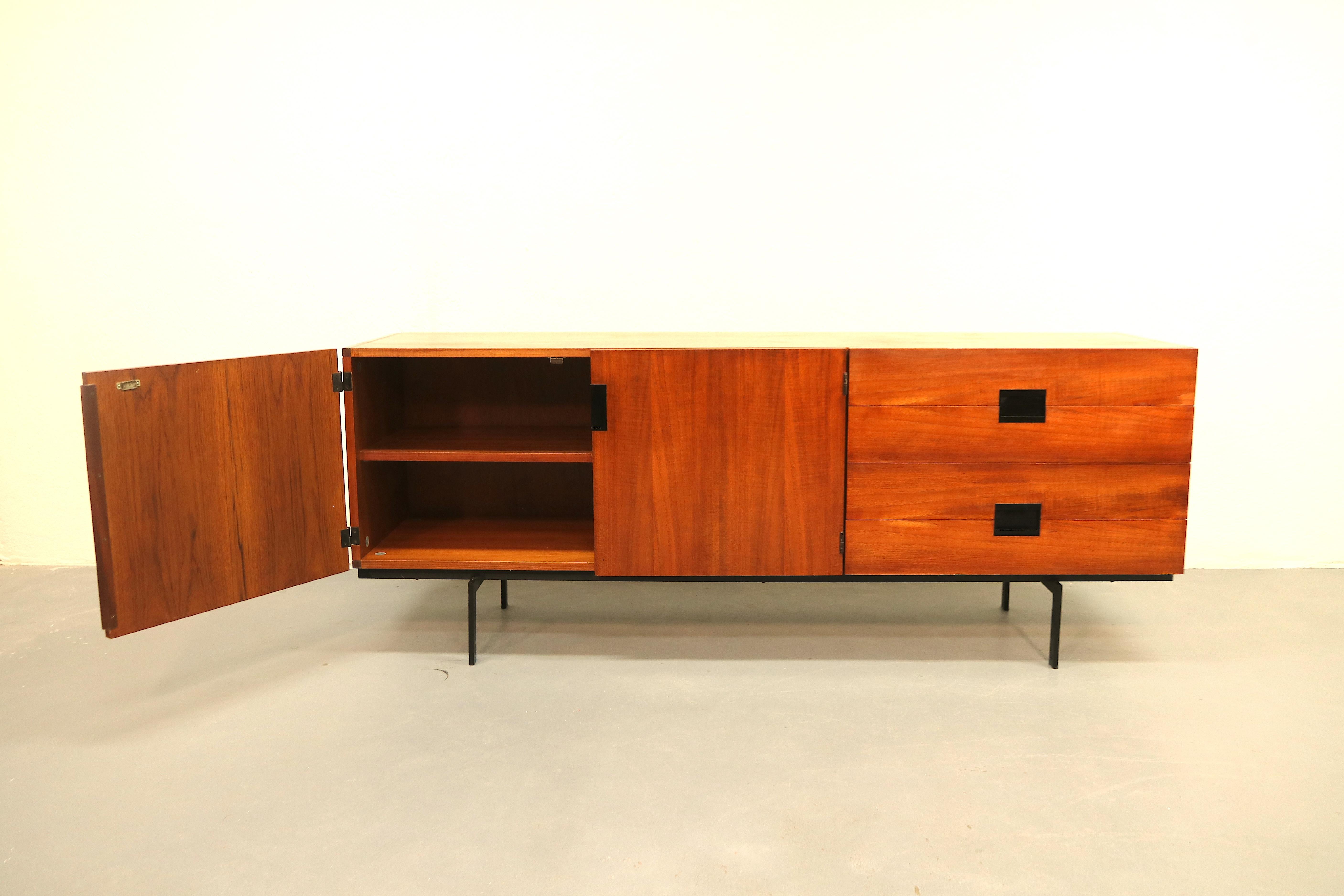 Dutch Mid-Century Modern iconic sideboard or credenza model DU04 (2 doors, wide drawers) by Cees Braakman for manufacturer Pastoe. This is the rarest and most sought-after model, it is slightly smaller than the DU03 model, has 2 larger doors