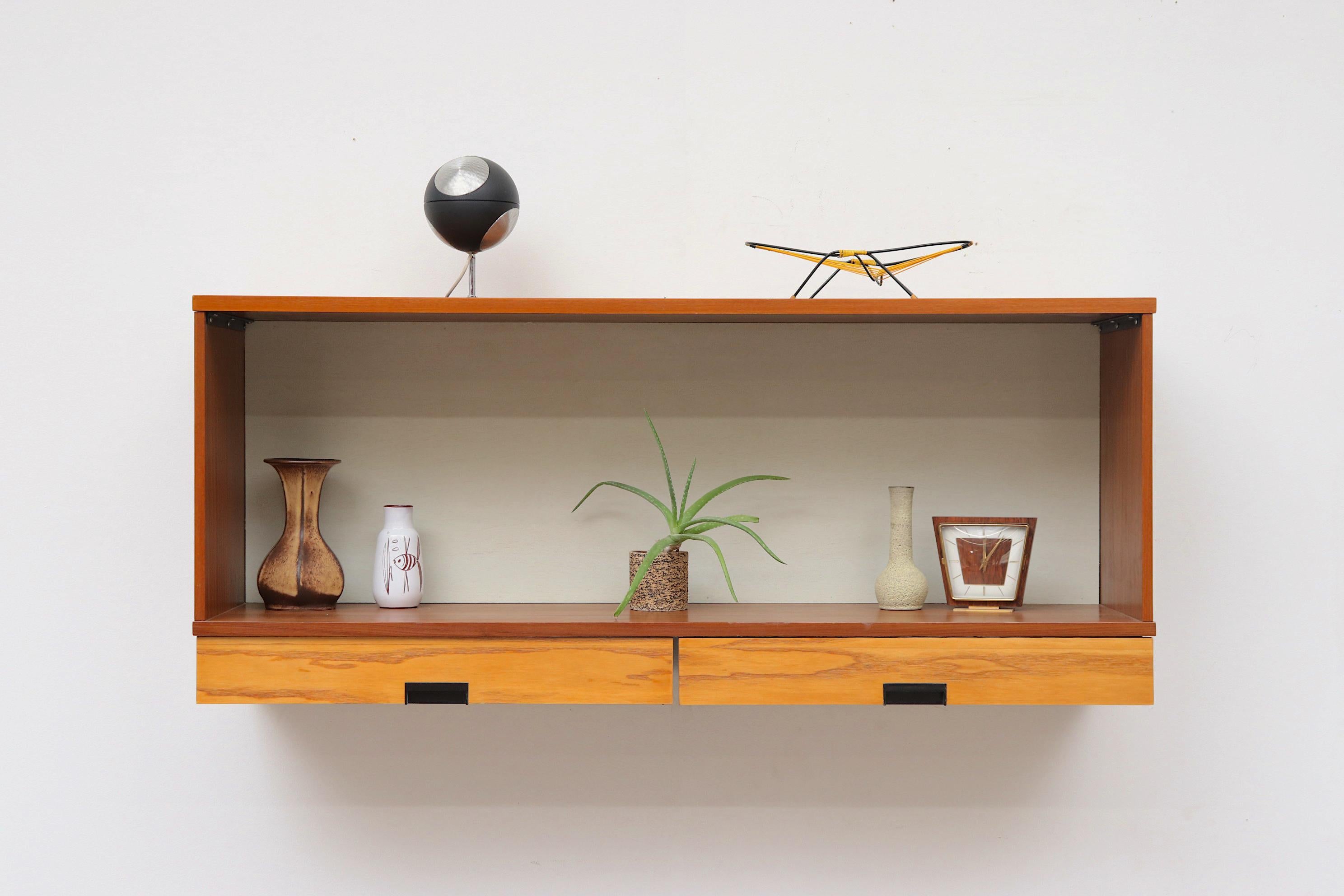 Mid-century, two-toned Japanese Series wall mount cabinet with blonde drawers and teak cabinet body. Drawers have signature black drawer pulls.  a beautiful example of Dutch mid-century designer Cees Braakman's Japanese series in which sleek and