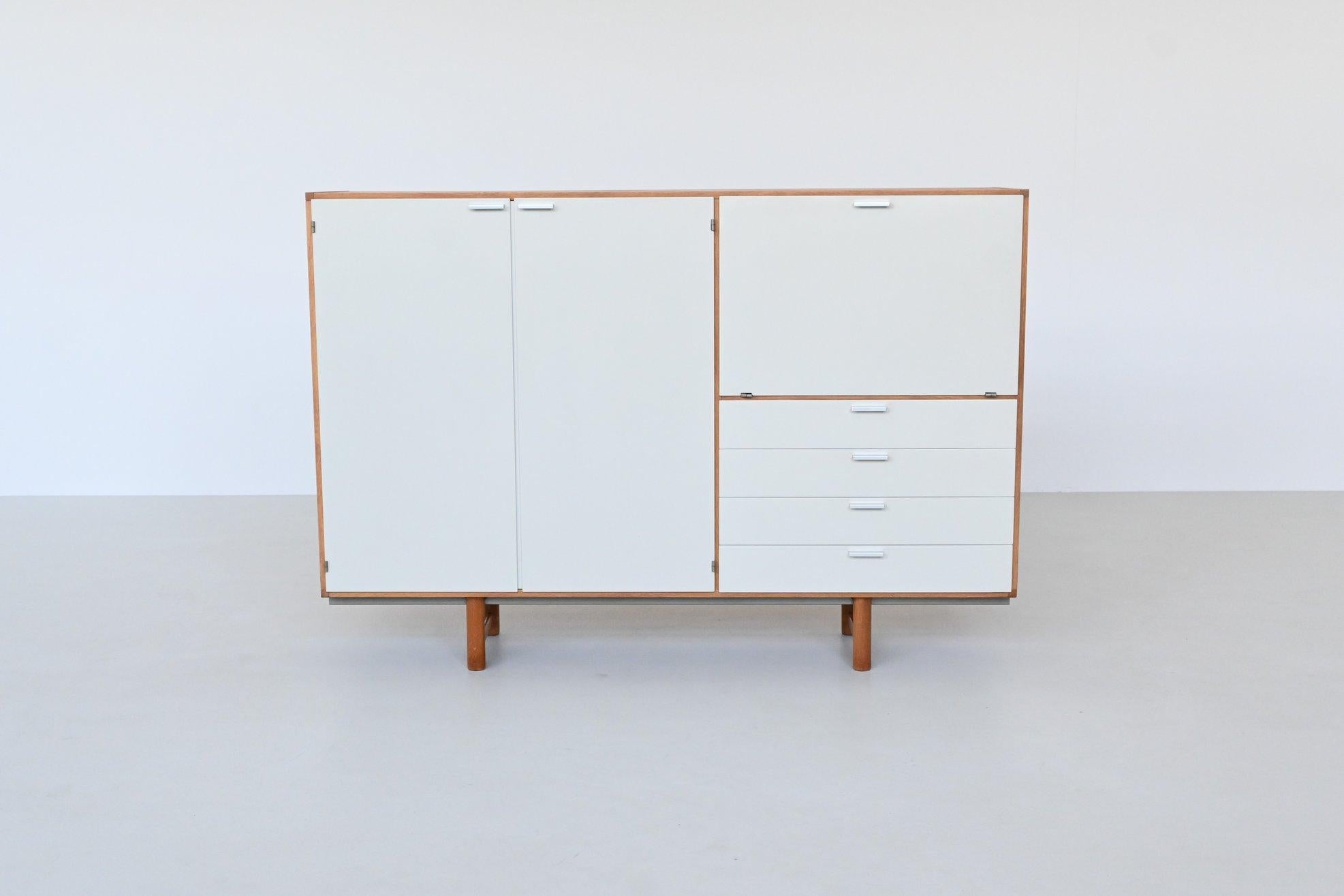 Beautiful highboard from the Made-To-Measure Series designed by Cees Braakman for Pastoe UMS, The Netherlands 1965. This highboard is elegantly crafted with a robust oak casing and legs, presenting a stark, clean silhouette characteristic of