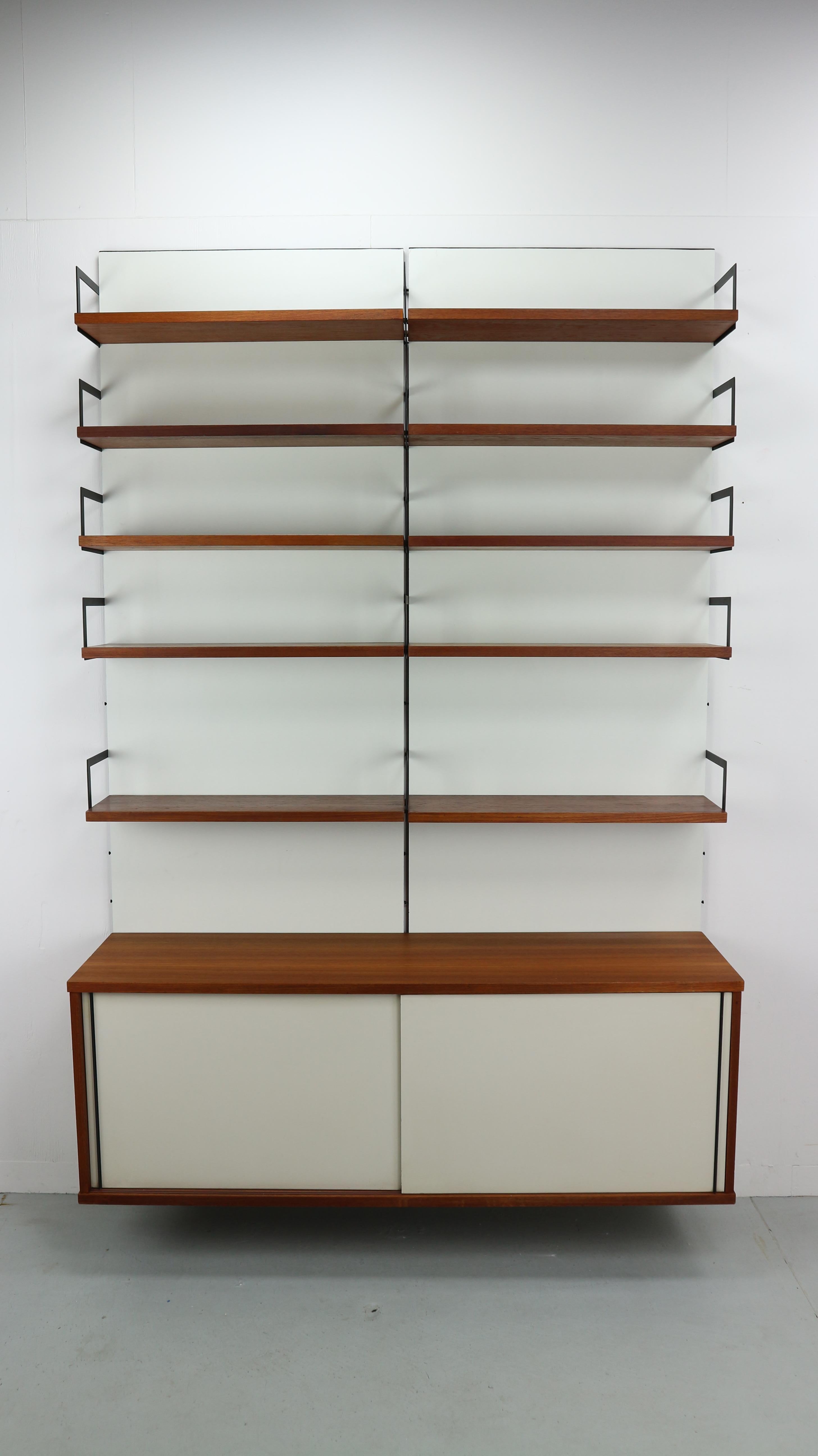 This modular wall cabinet is part of the Japanese series of Cees Braakman for Pastoe. The piece is divided over two panels, the 10 shelves could be arranged to your own wishes. The large storage cabinet on the bottom covers both panels. Highly