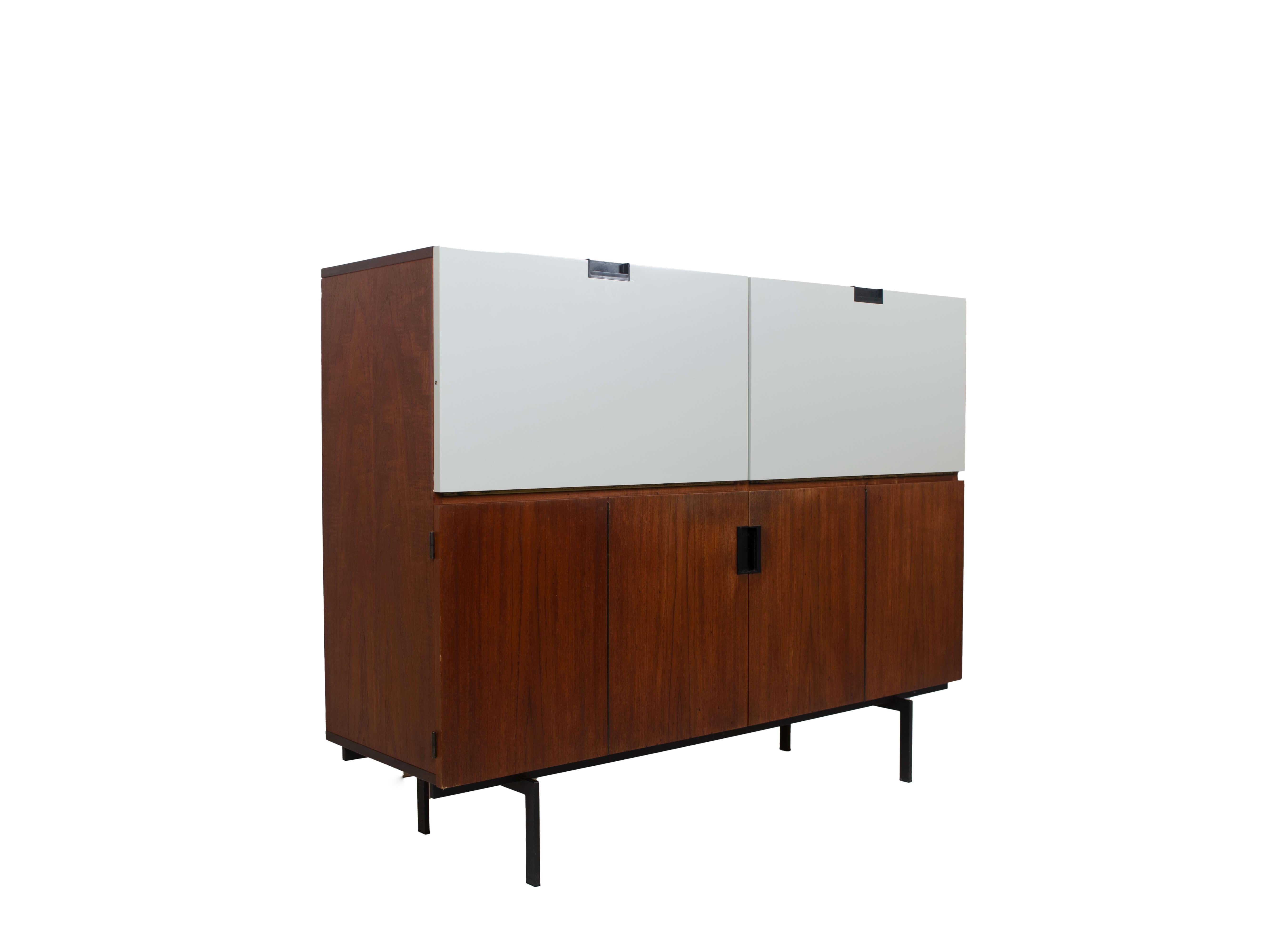 Impressive Cees Braakman pastoe cabinet from the Japanese Series CU-07, the Netherlands 1960s. This example of Dutch Design is known for the usage of the off-white formica doors in combination with teak. Iconic are the black handles. This Cabinet