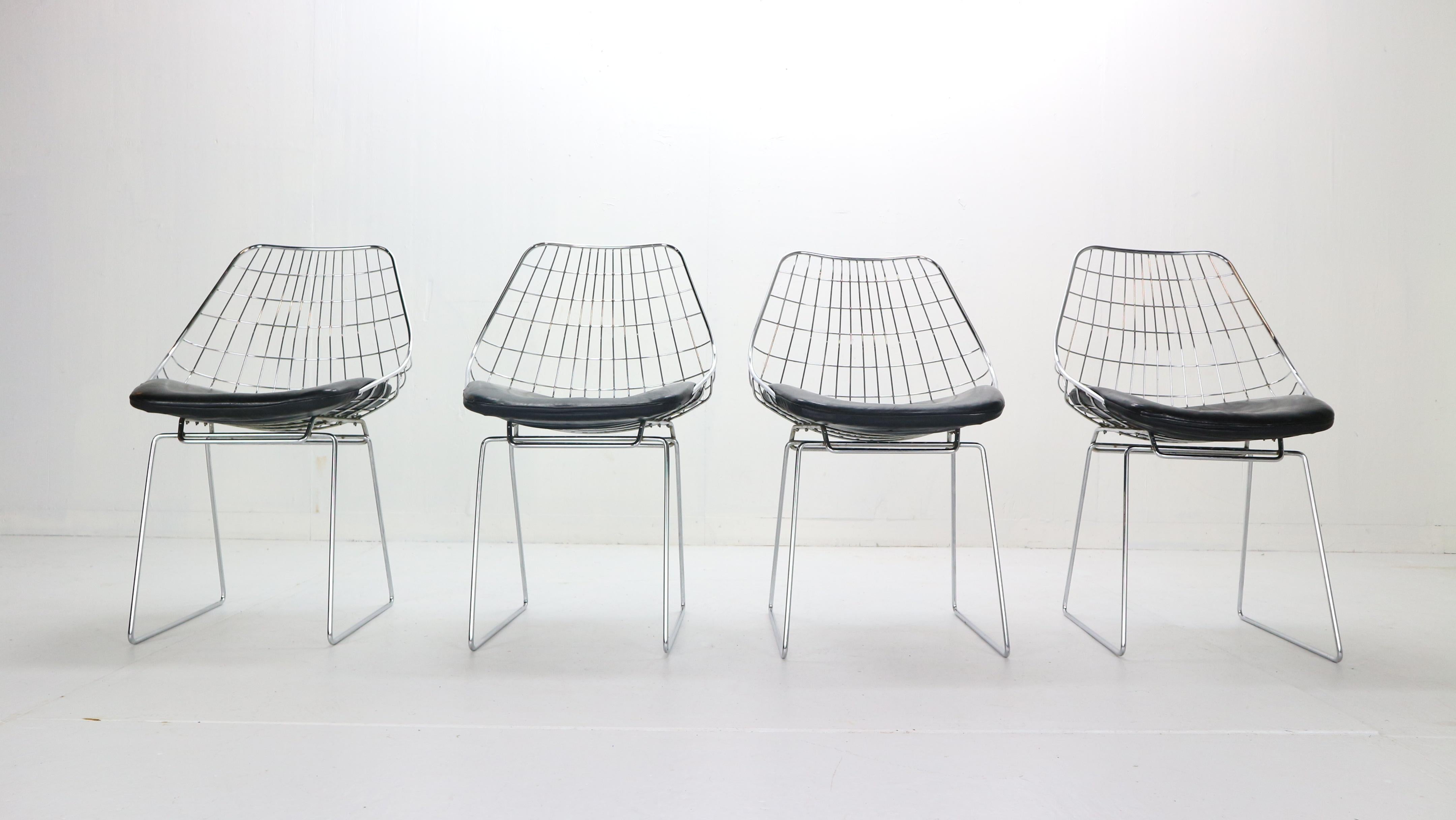 Mid-Century Modern period set of 4 wire chairs designed by Cees Braakman for Pastoe, 1950s, Netherlands.
Model No.- SM05. Chrome wire chair with black leather cushions. 
At the time of its introduction in the mid-1950s one of the few European