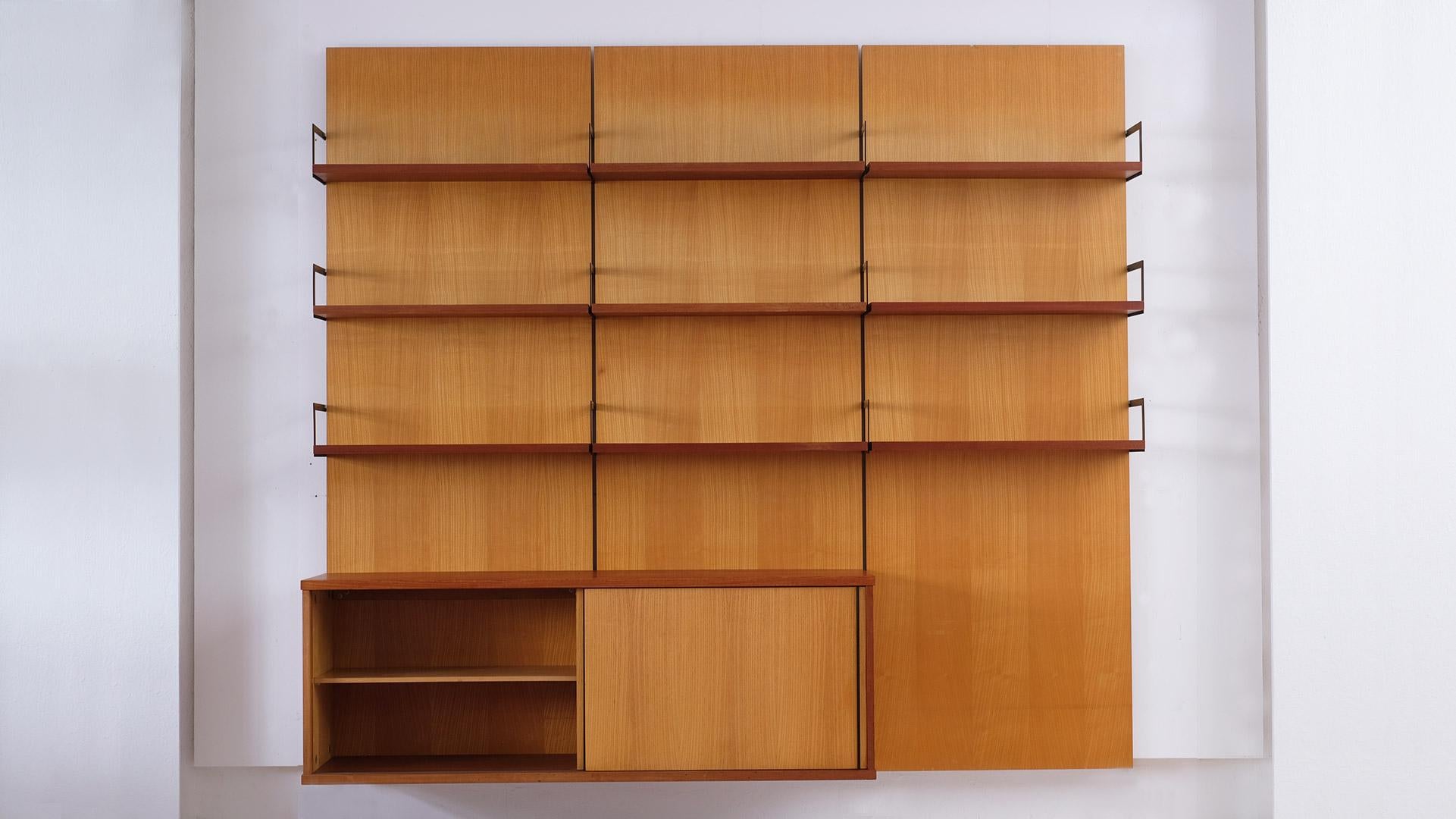 Rare and beautiful wall unit with back panels in ash and contrasting teak shelves and sideboard designed by Cees Braakman for UMS Pastoe, Utrecht, 1958.