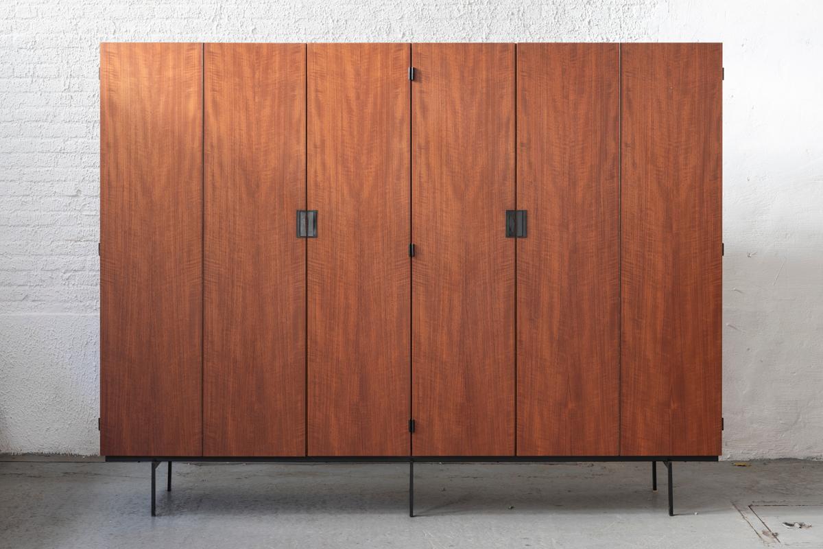 Wardrobe ‘KU16’ from the Japanese Series designed by Cees Braakman and produced by Pastoe in the Netherlands in 1958. The wardrobe is made in teak and stands on a metal base. The doors all have the original signature, black plastic grips. On the