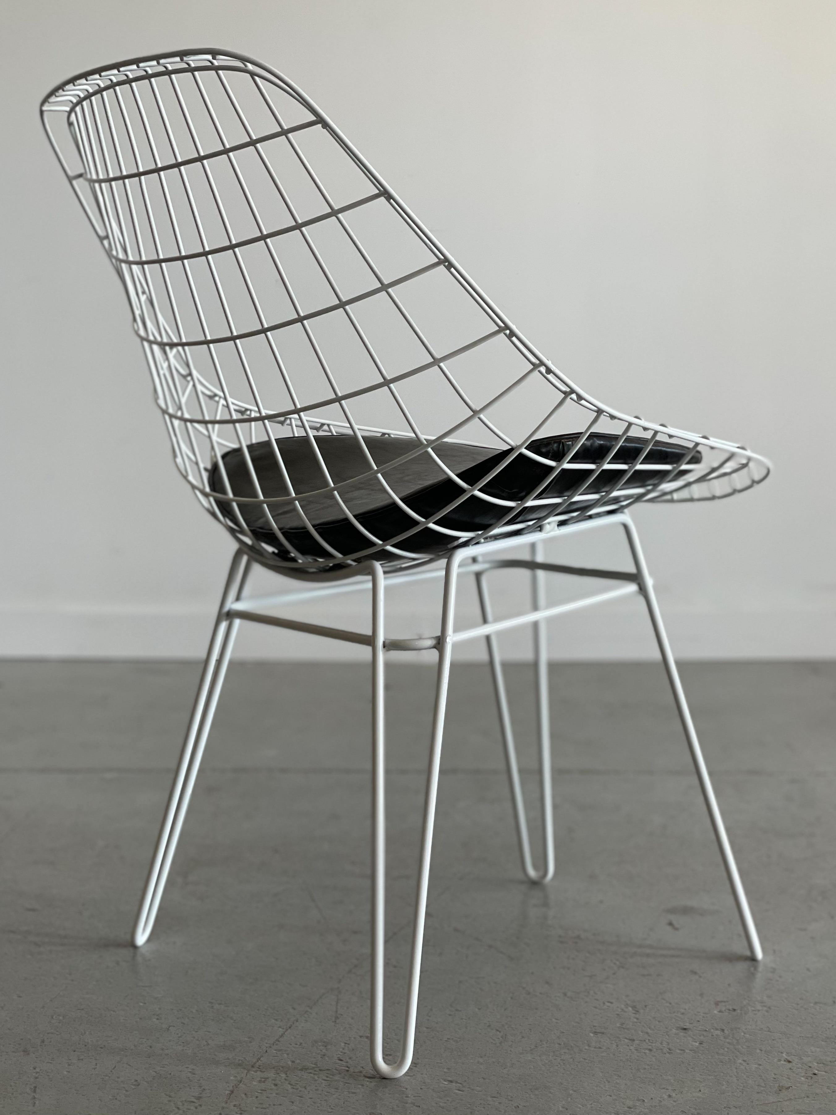 Amazing sculptural wire chair designed by Cees Braakman for Pastoe. This piece features a wire mesh body upon an angular hairpin base. It comes with original detachable vinyl seat pad. We haven’t seen another quite like it. Measures 23” W x 24” D x