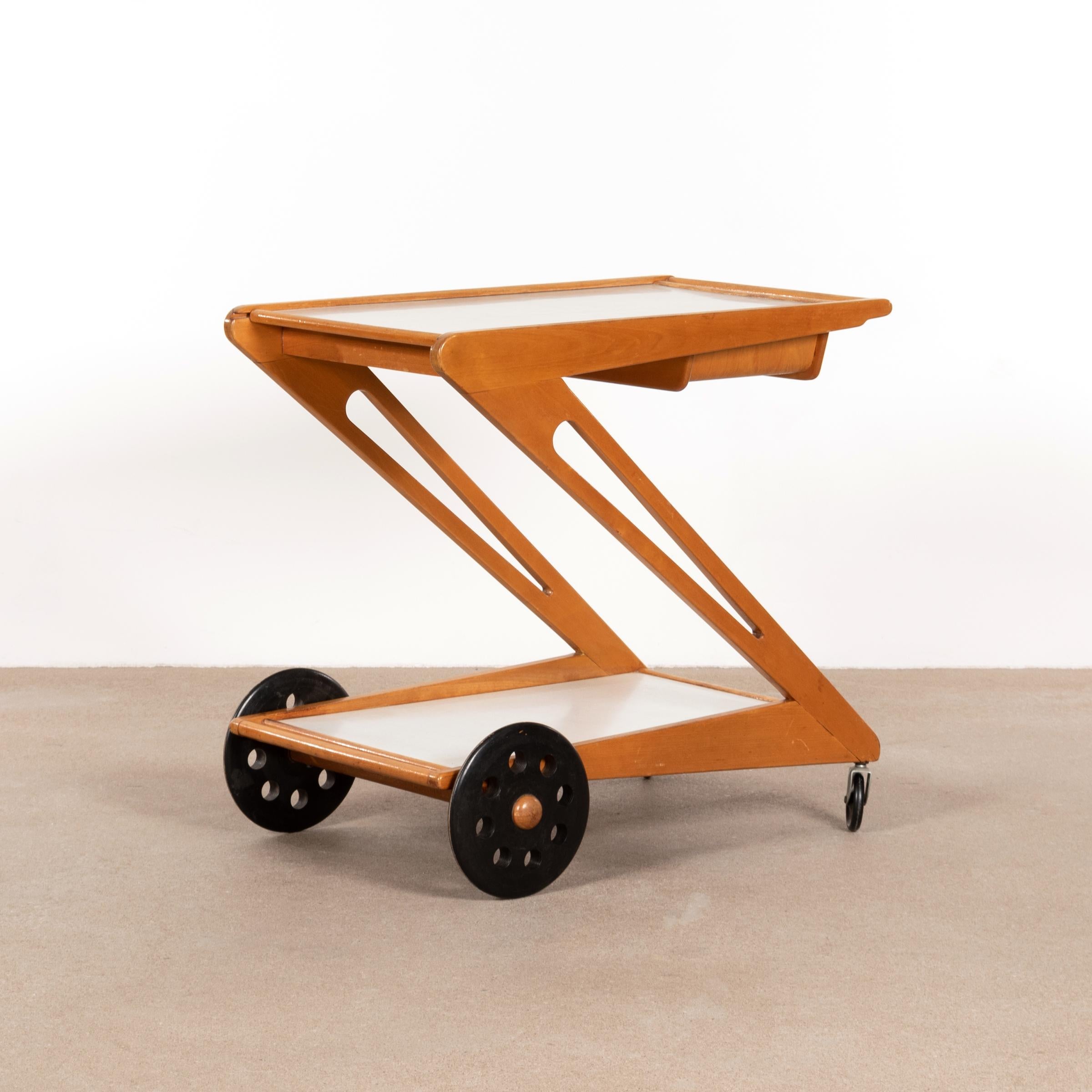 Elegant and hard to find trolley (Mobilo PE03) designed by Cees Braakman in 1953 for UMS Pastoe. Maple/oak wooden Z-shaped frame with two laminated trays. The top tray can slide open and/or removed with a small wooden serving basket underneath.