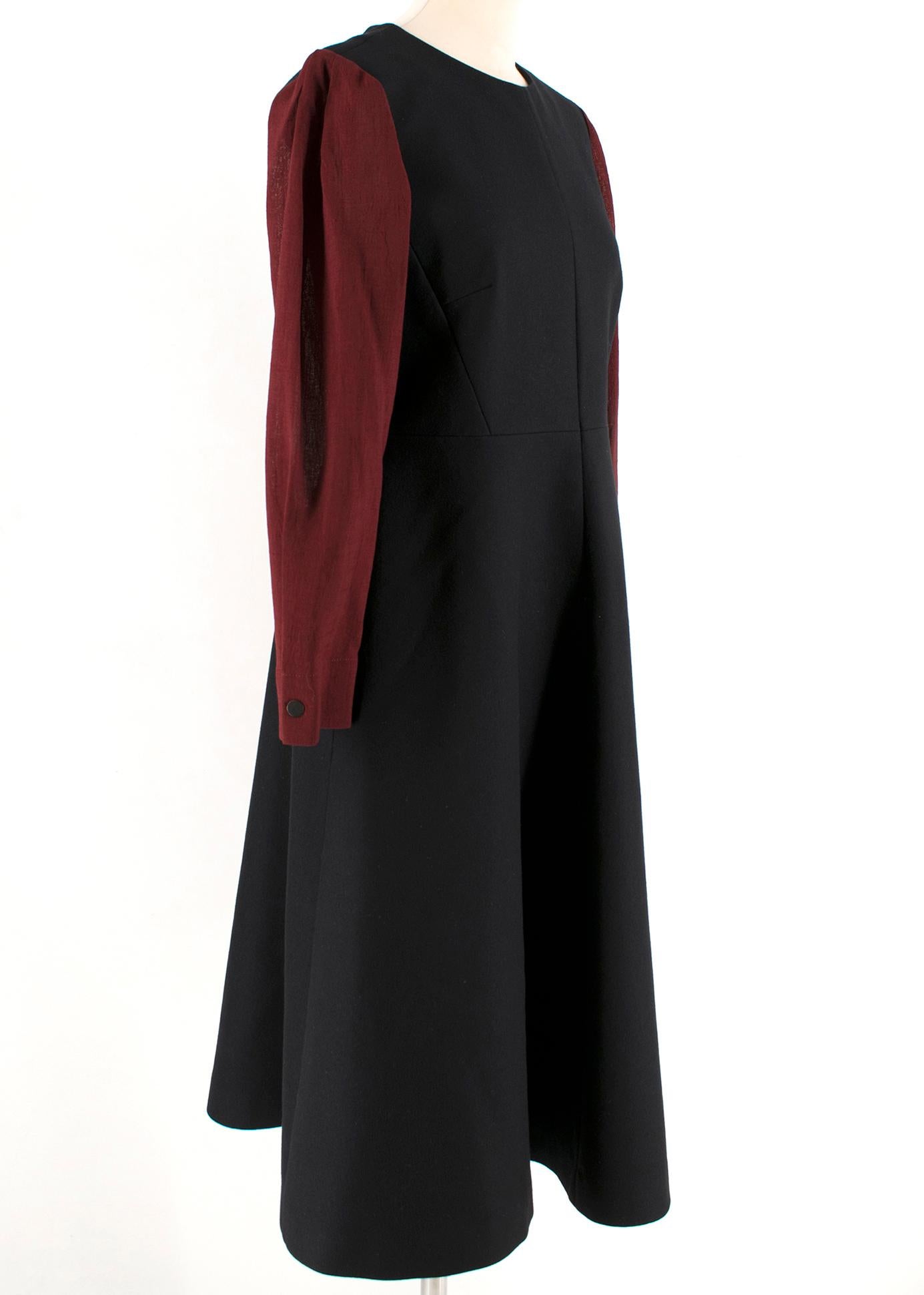 Cefinn Black & Red Midi Dress

Black dress with long sleeves in red,
Fitted waist, fitted to the shoulders,
Side pockets,
Rear zip fastening,
Button cuff,
A-line skirt design

Please note, these items are pre-owned and may show some signs of