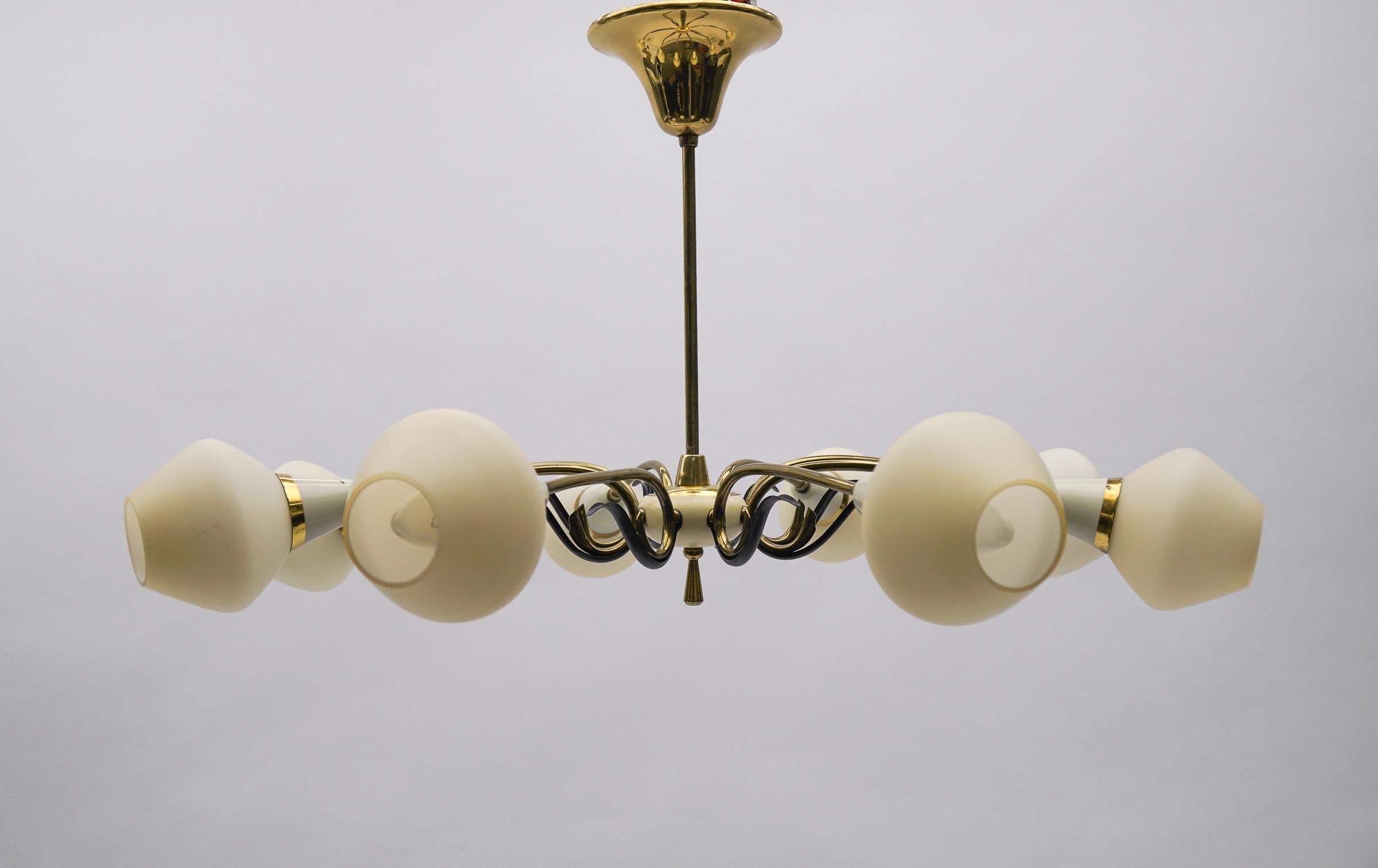 Executed in glass, brass and metal. The lamp needs 8 x E14 / E15 Edison screw fit bulb, is wired, in working condition and runs both on 110 / 230 volt.

Our lamps are checked, cleaned and are suitable for use in the USA.