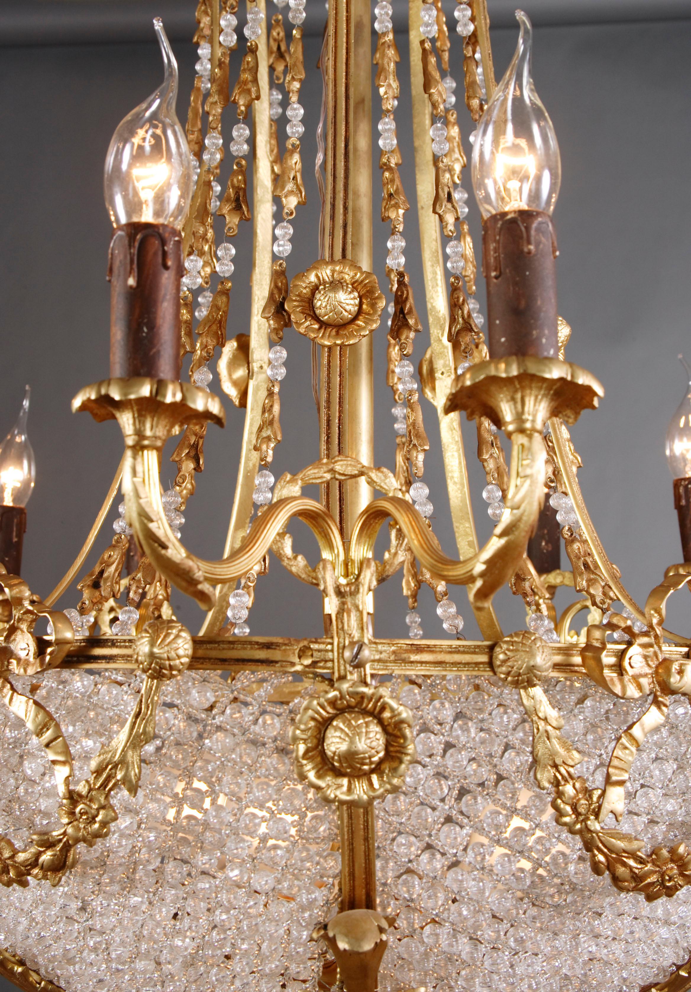 Ceiling candelabra in Louis XVI Style
 Profile framed corpus from netted ball prism. Ten light arms.
Measures: Diameter: 64 cm, height: 90 cm.
 