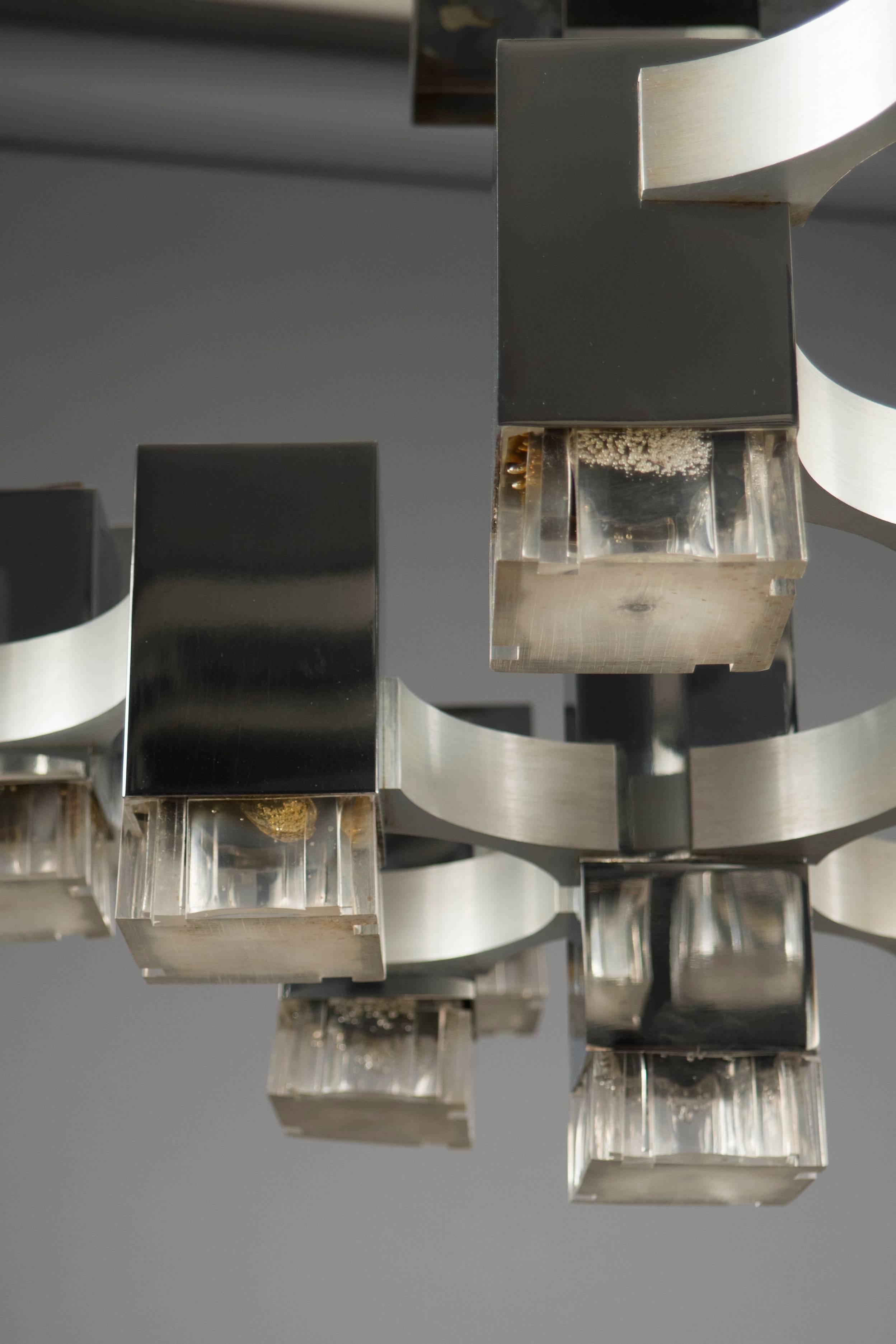 Chrome-plated structure featuring 17 textured acrylic lights, from the “cubic” series. Some of the shades with slight heat marks.
 