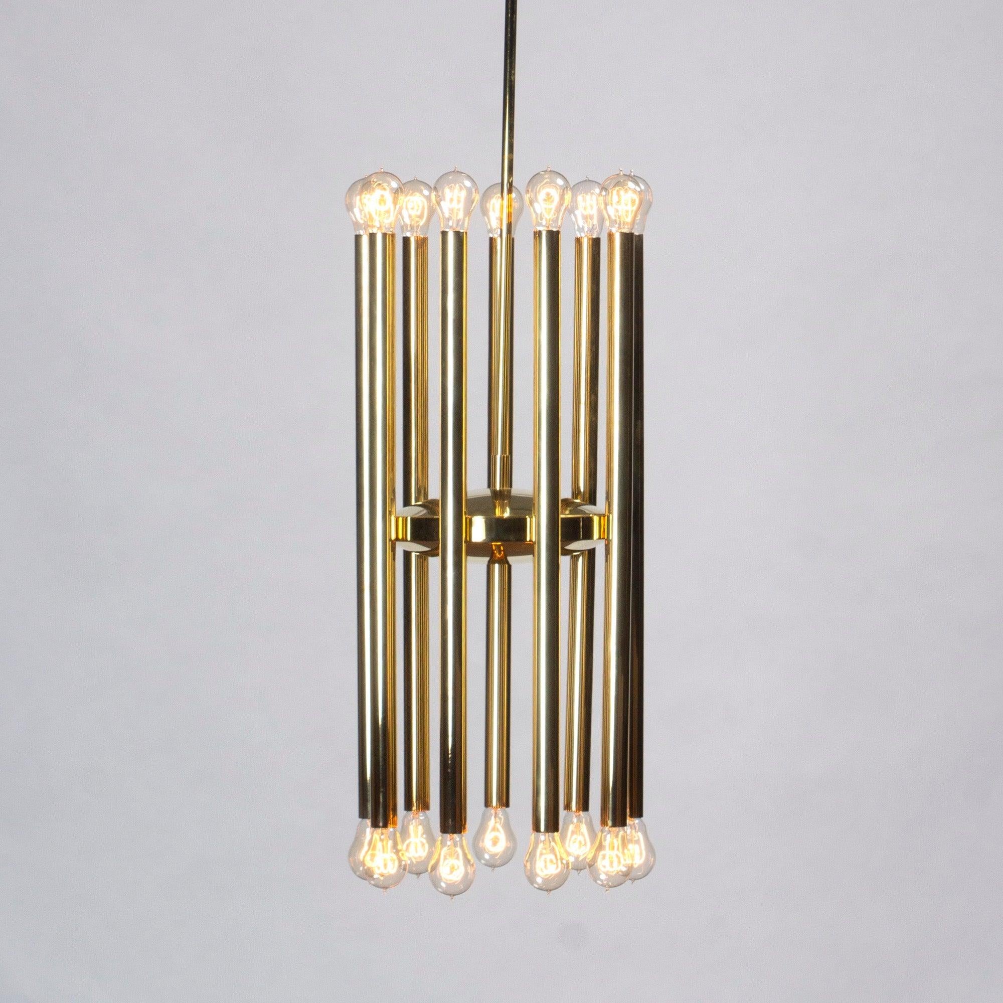 A dramatic brass ceiling fixture with nine adjustable tubes encircling a brass disc.