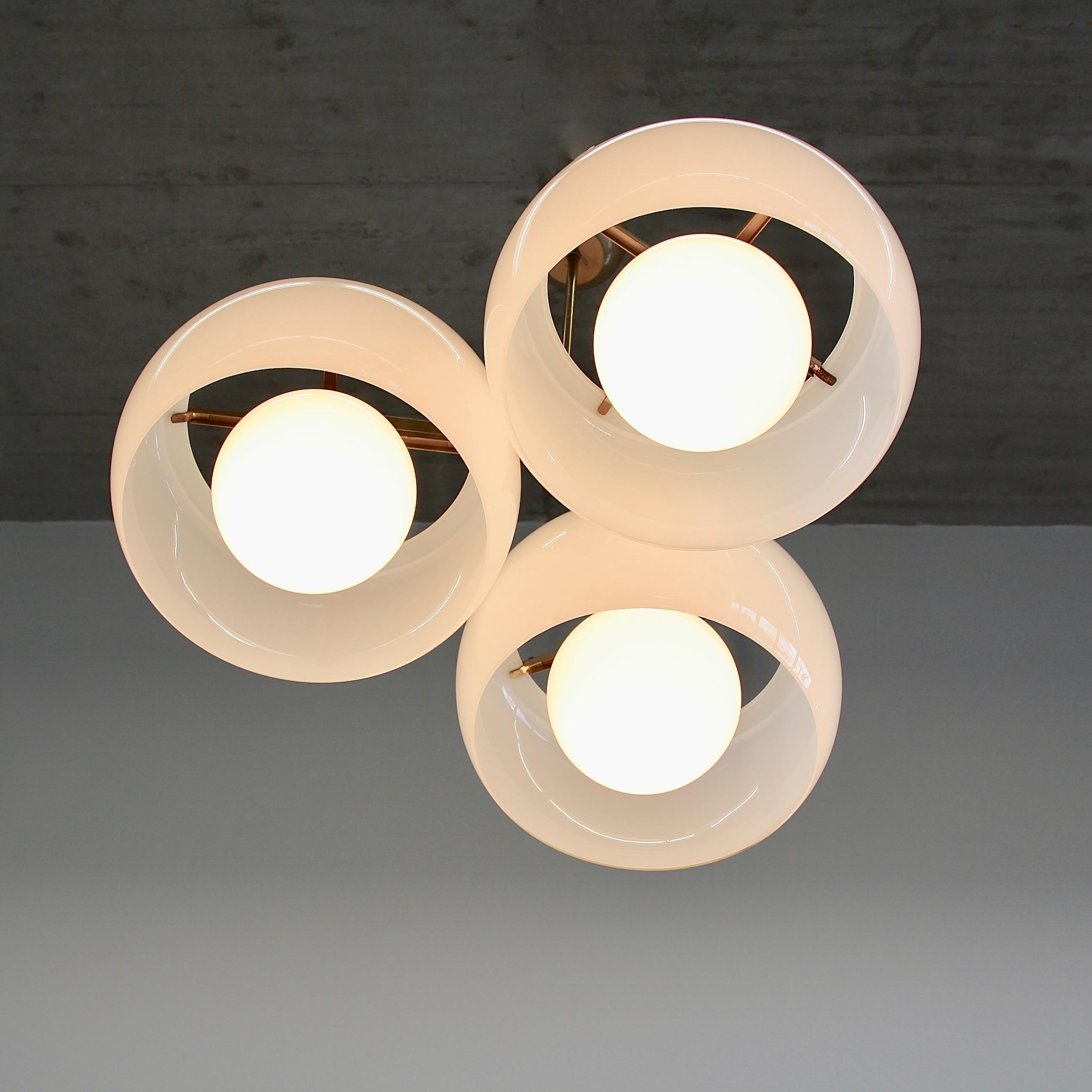 Ceiling lamp, designed by Vico Magistretti, Italy, Artemide, 1961.

The Triclinio ceiling lamp with 3 double diffuser glass shades. Opal glass and original bronzed metal structure.

Reference: Repertorio del Design Italiano, 2 vols. p 91,