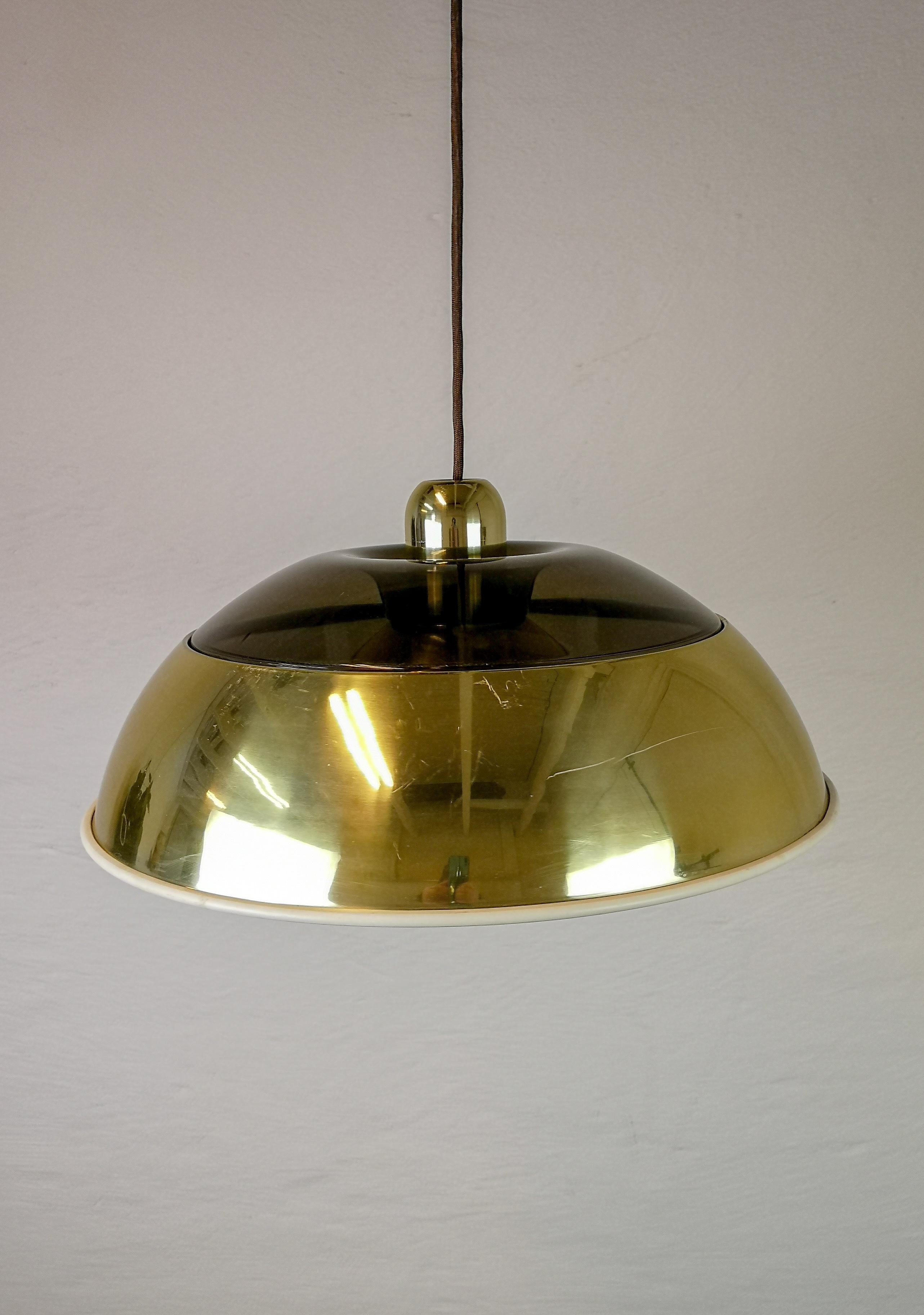 This large ceiling lamp was produced in the 1970s for Fagerhults Belysning, Sweden. The top is made out of dark shade plastic and the lower part in gold looking metal.

Good fair working condition. Scratches on gold metal.

Measures: H 23 cm, D