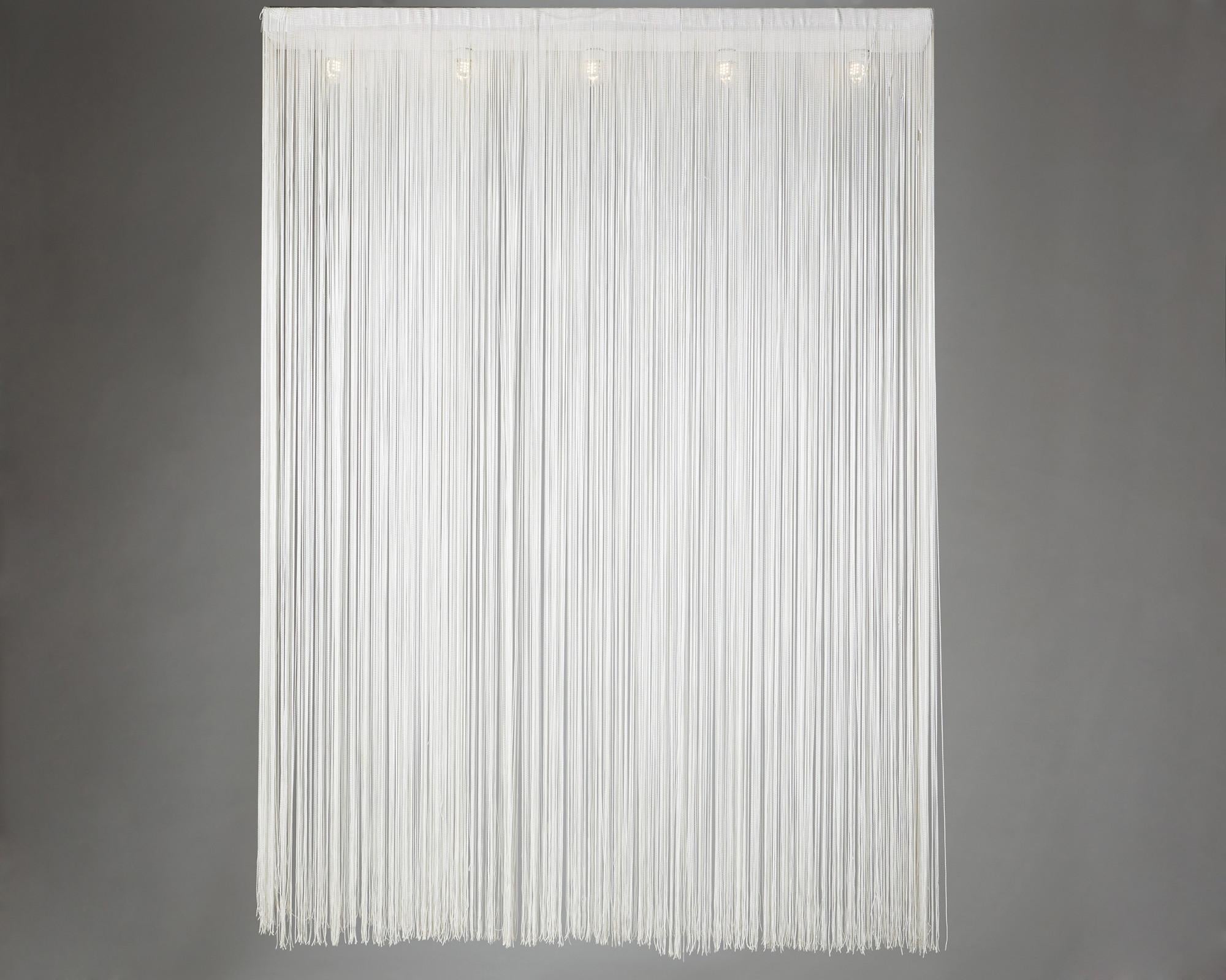 Ceiling lamp Garbo designed by Mariyo Yagi for Sirrah,
Italy 1980s

Lacquered steel and synthetic fringes.

Measurements:
W: 112 cm/ 40''
L: 162 cm/ 5' 3 3/4''
D: 12 cm/ 4 3/4''