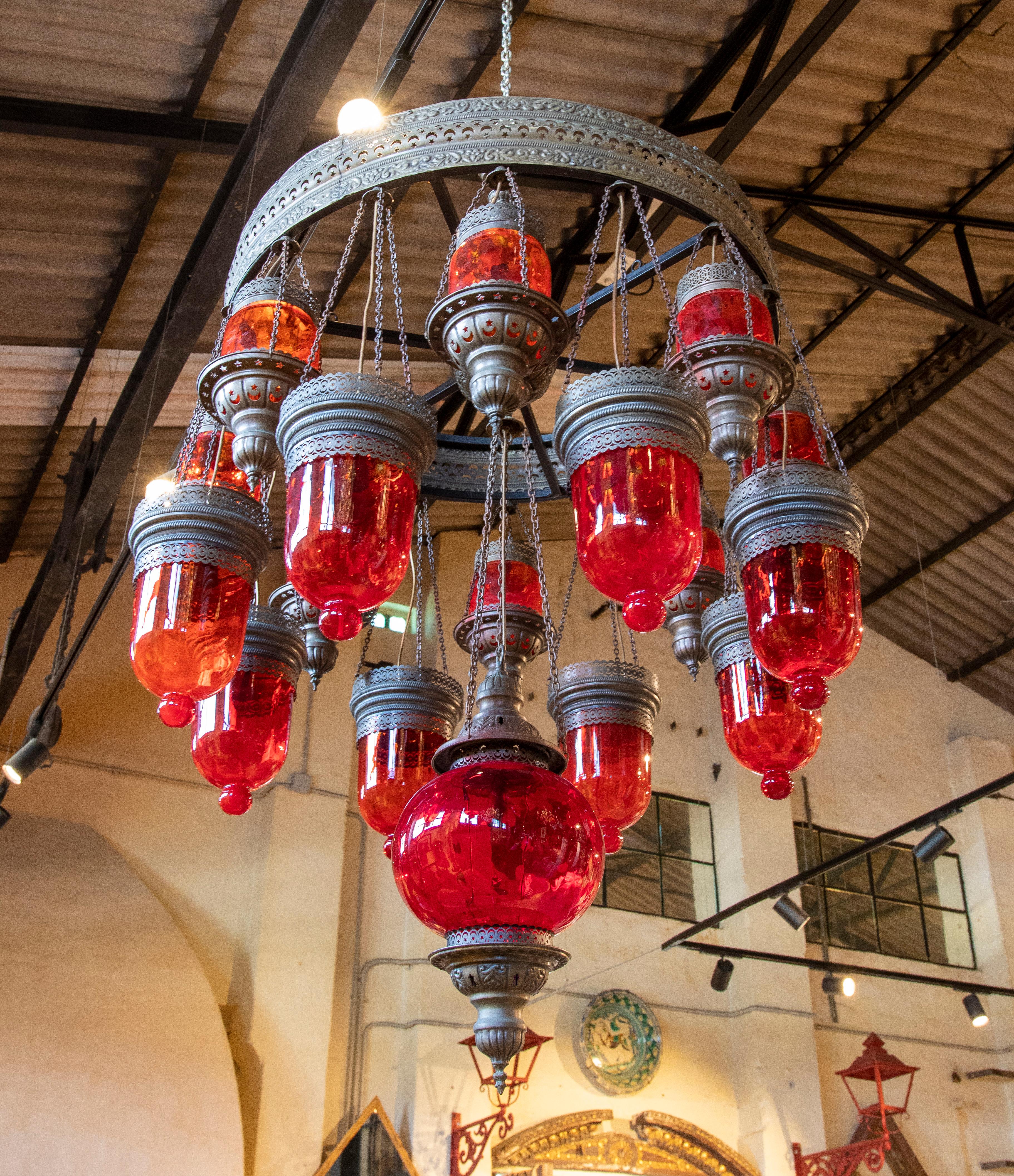 Ceiling lamp made of metal, iron and decorative glass in red colour.