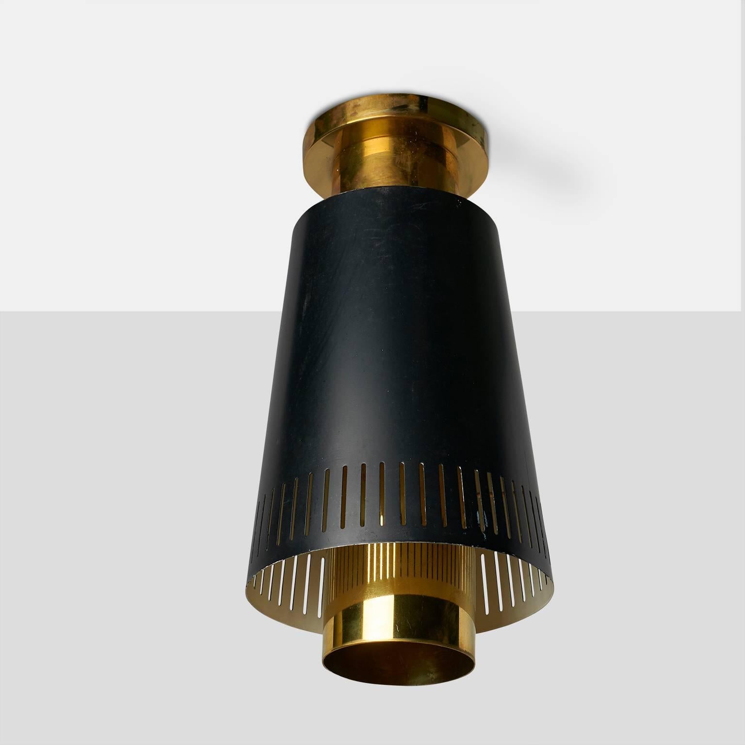 A Paavo Tynell flush mount ceiling lamp model #9067 with a black enameled shade made with perforated edge detail for Taito Oy,
Finland, circa 1950s.