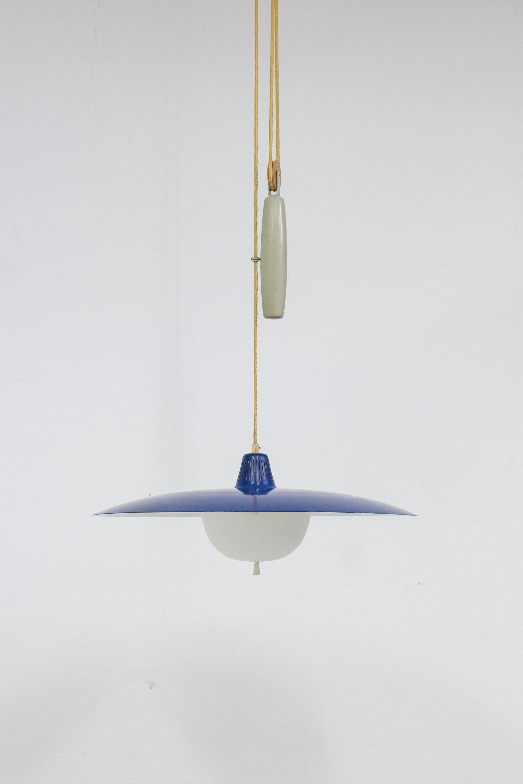 Ceiling lamp model T-6H designed by Alf Svensson. Produced in Sweden by Bergboms during the 1950s. Large lamp shade in blue and white lacquered aluminum with brass details and original opal glass shade. Ceiling cup and counter weight in grey