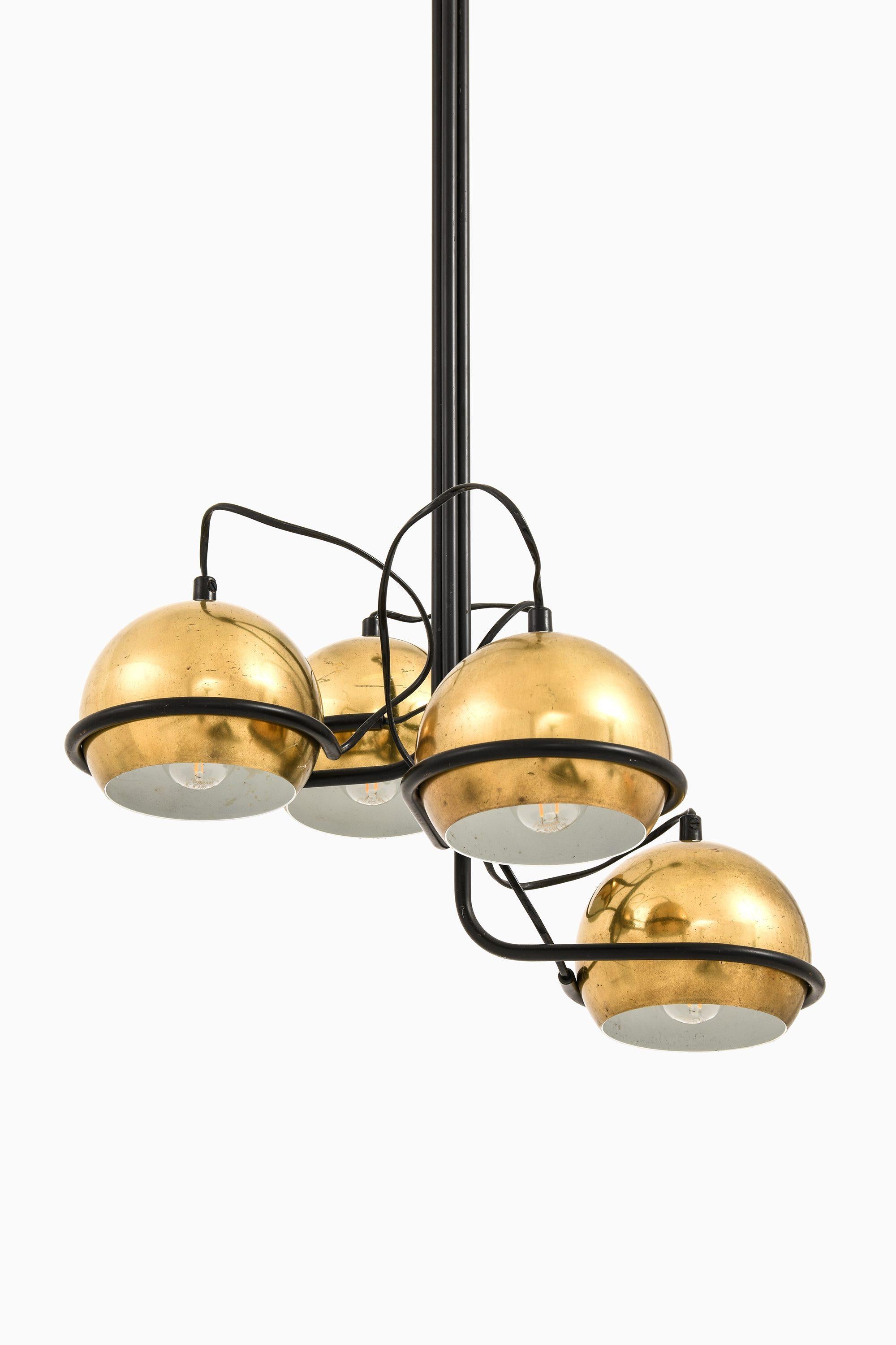 Ceiling Lamp in Black Lacquered Metal and Brass, 1960's

Additional Information:
Material: Black lacquered metal, brass
Style: Mid century, Scandinavian
Ceiling lamp model Polaris
Produced by Aris Oy in Finland
Dimensions (W x D x H): 43 x 43 x 93