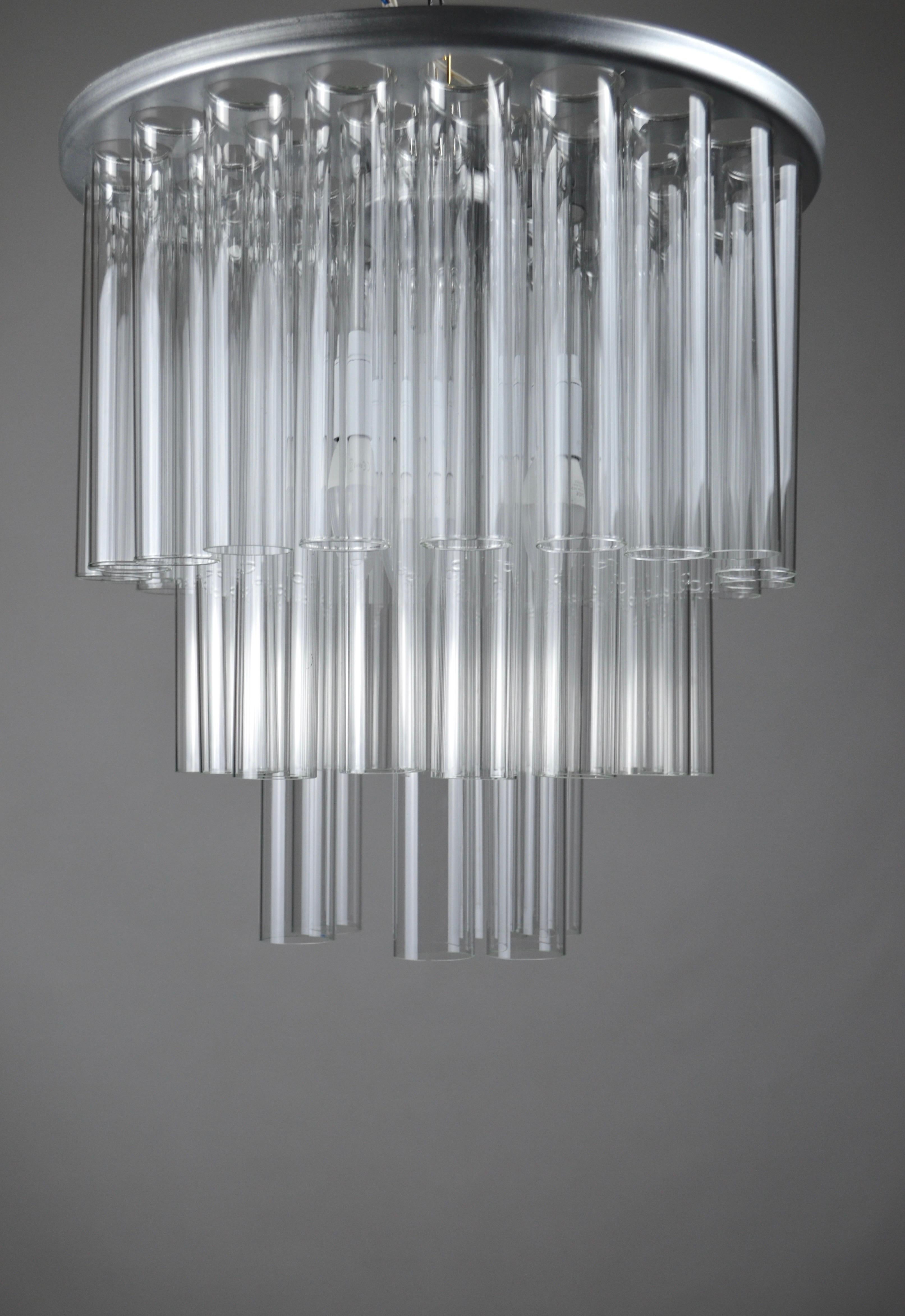 Rare and spectacular ceiling lamp made by the Portuguese lamp designer, Antonio Da Piedade.
It is composed of a painted aluminum structure (must be fixed to the ceiling) and 42 glass tubes 40 mm in diameter.
6 tubes 40 cm long
31 tubes 15 cm