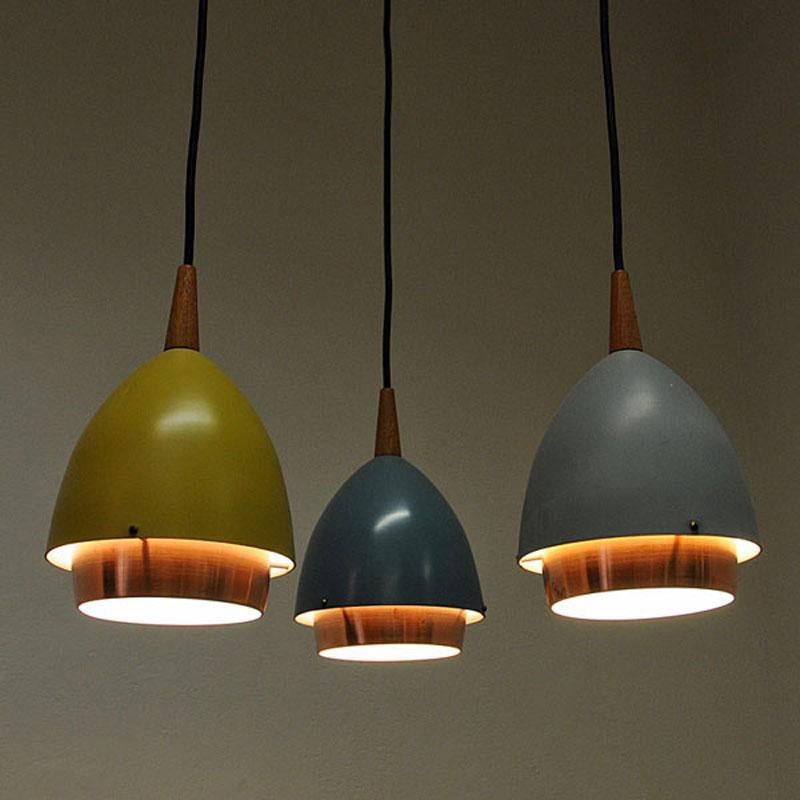 Lovely designed ceiling lamp with three colorful domes by T. Røste & Co, Norway, 1950s. A great shape pendant with metal domes in yellow, light blue and blue original lacquer. Inner shades of copper. The copper splint in the middle are adjustable up