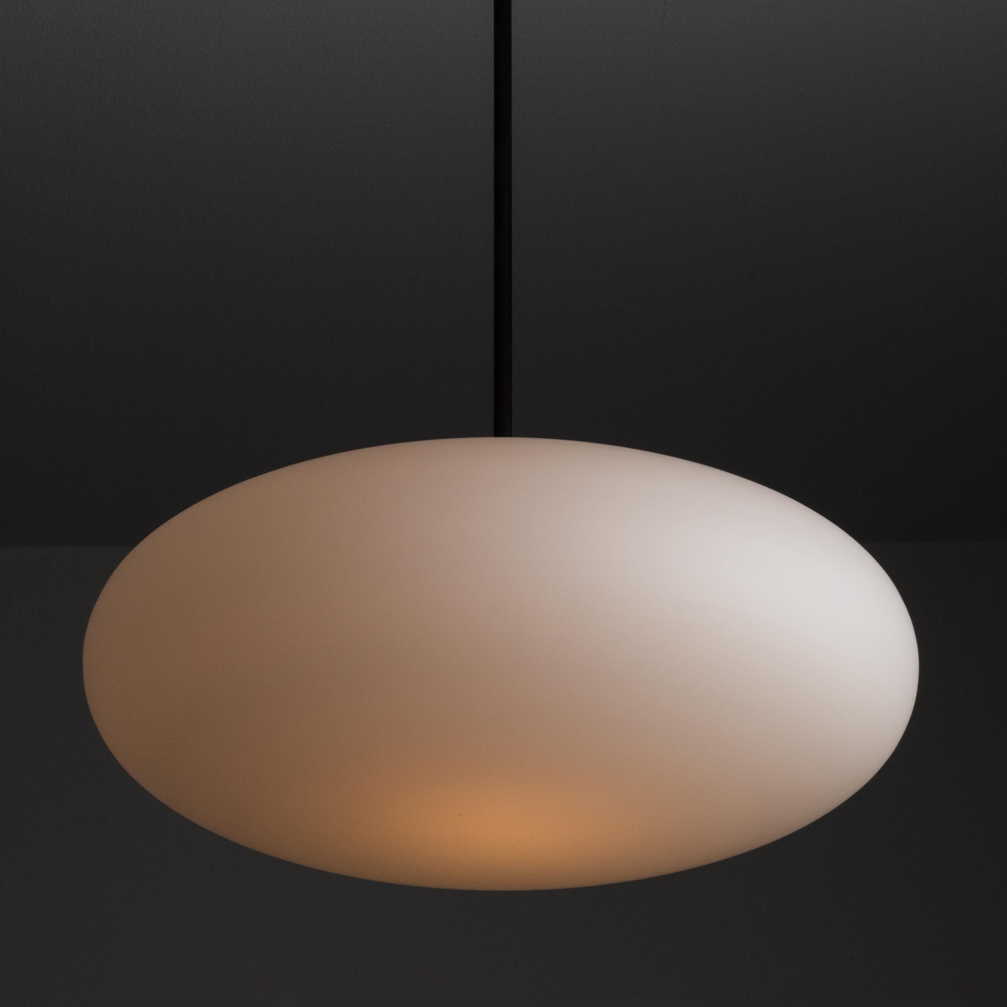 Ceiling Light by Angelo Lelii for Arredoluce. Designed and manufactured in Italy, circa the 1960s. Beautiful white opal saucer is suspended by a patinated brass stem. Wired for US standards. Custom canopy for US applications. Bulb is not included.