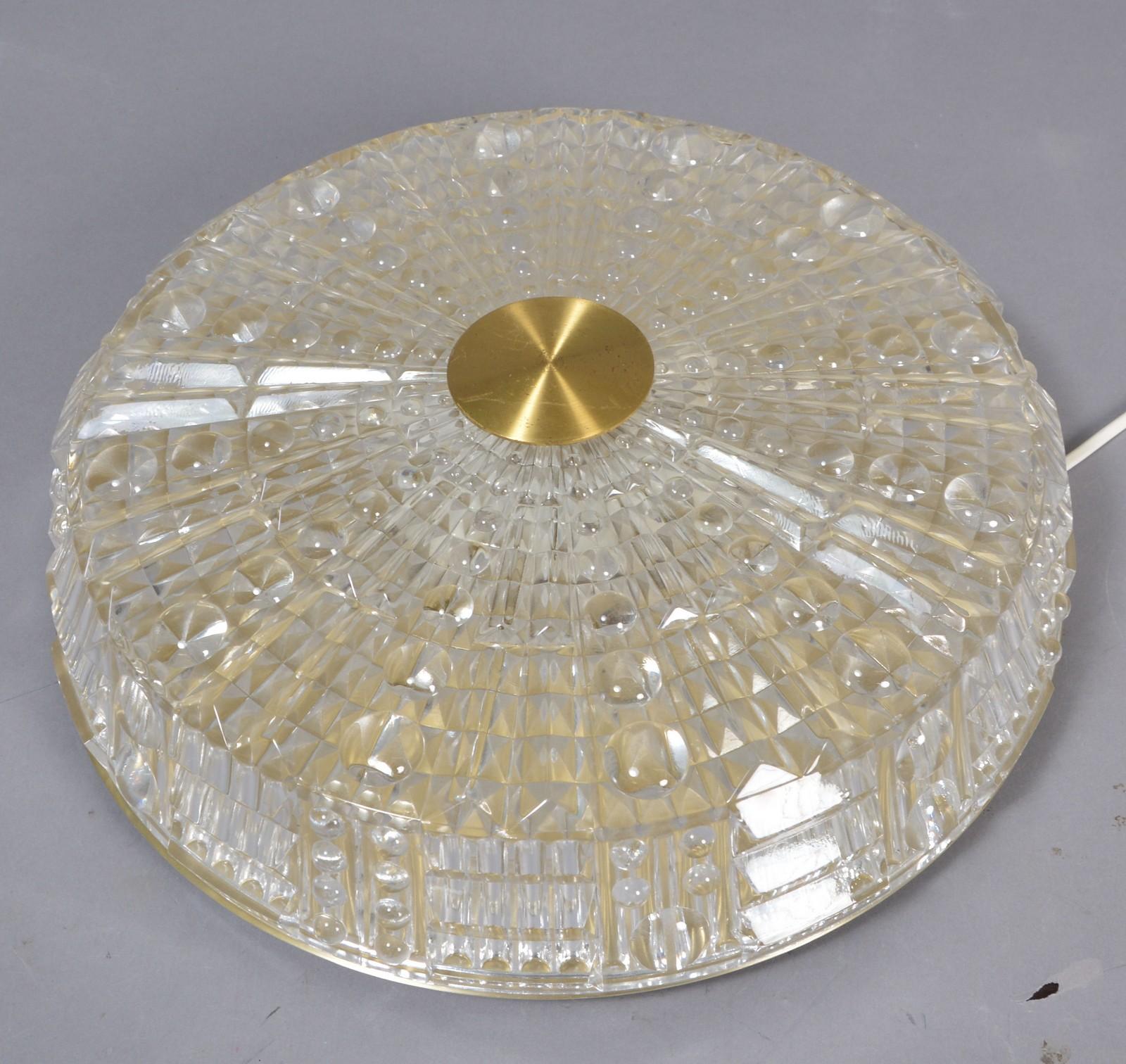 Flushmount ceiling fixture for Lyfa by Orrefors of Sweden, designed by Carl Fagerlund made of textured glass with brass mounting. 6 candelabra style sockets. Several available in this style.

 